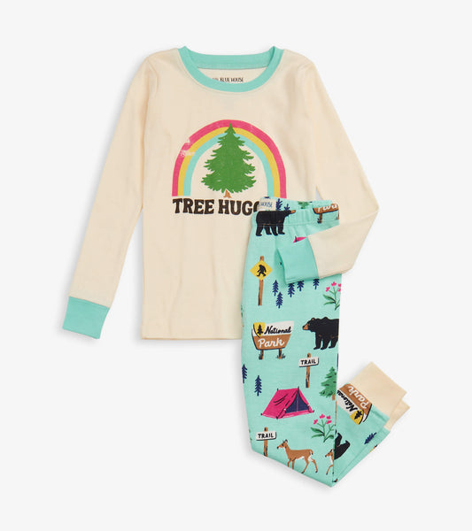 Cream long-sleeve top with "Tree Hugger" graphic and mint green pajama bottoms featuring camping and wildlife patterns.