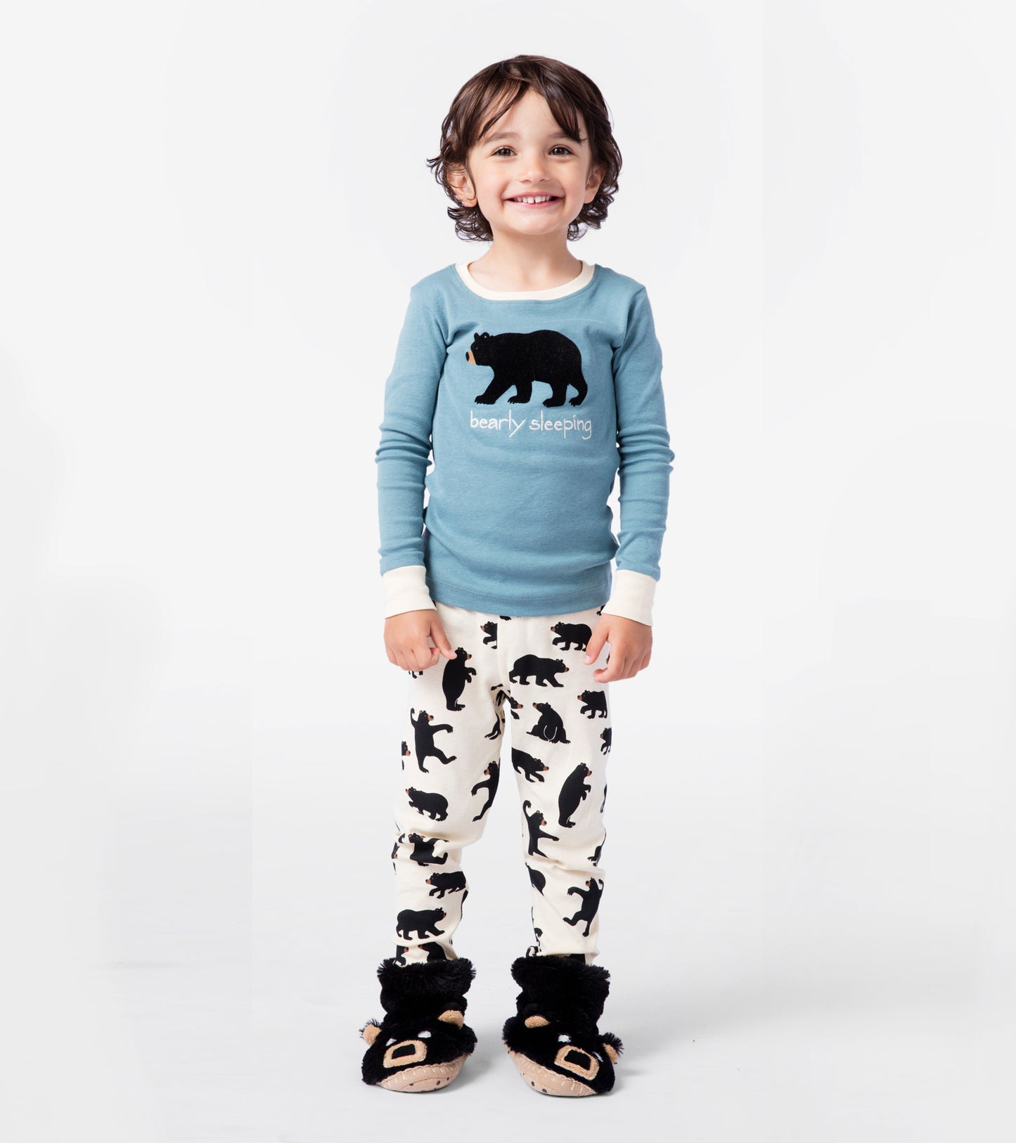 Blue long-sleeve pajama top with bear graphic, paired with cream pants featuring black bear silhouettes.
