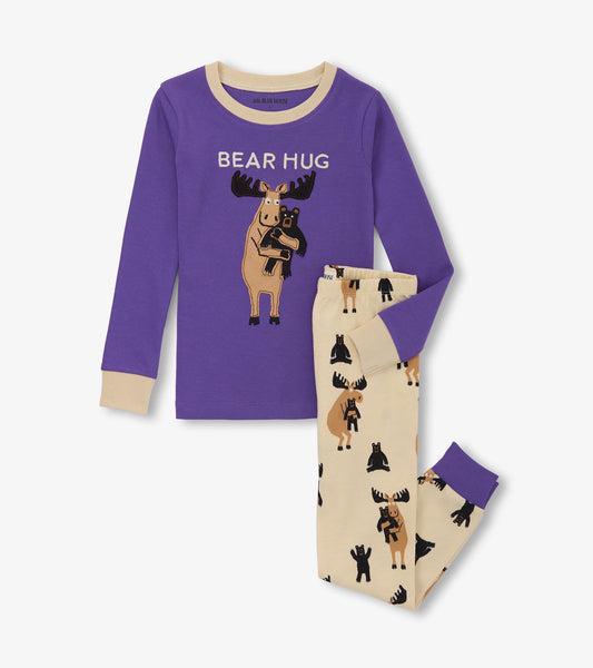 Purple long-sleeve pajama top with moose graphic, paired with cream pants featuring moose and bear prints.