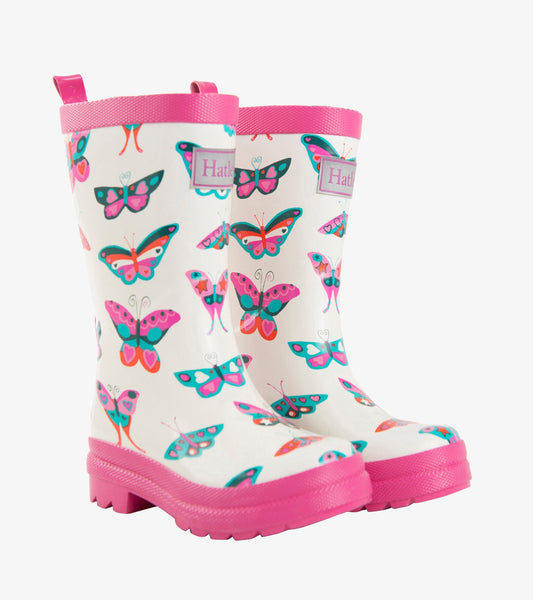 White rain boots with colorful butterfly patterns and pink soles and trim, designed for kids.