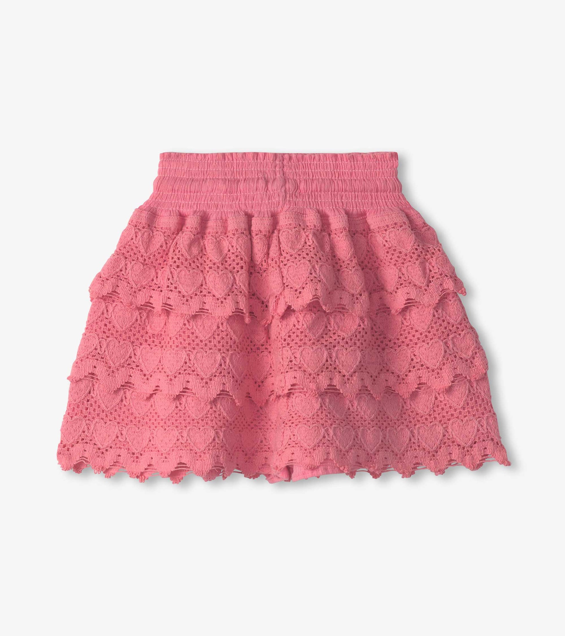 Pink skort featuring a layered design with heart patterns and a smocked waistband, ideal for casual wear.