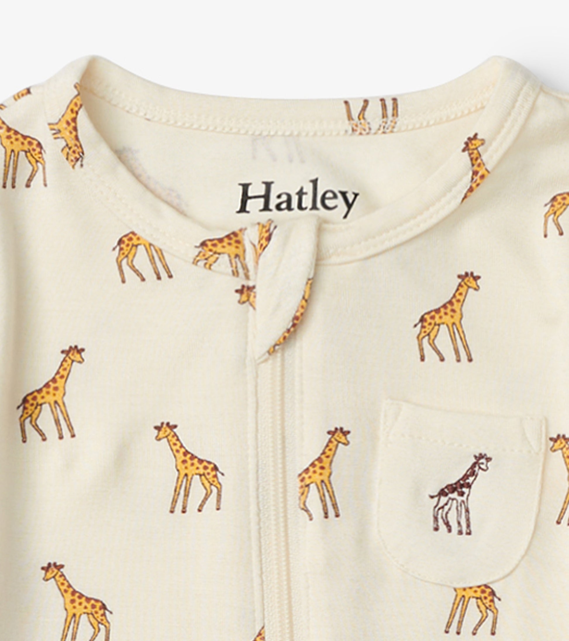 Cream footed sleeper featuring a playful giraffe print and a small pocket with a giraffe design.