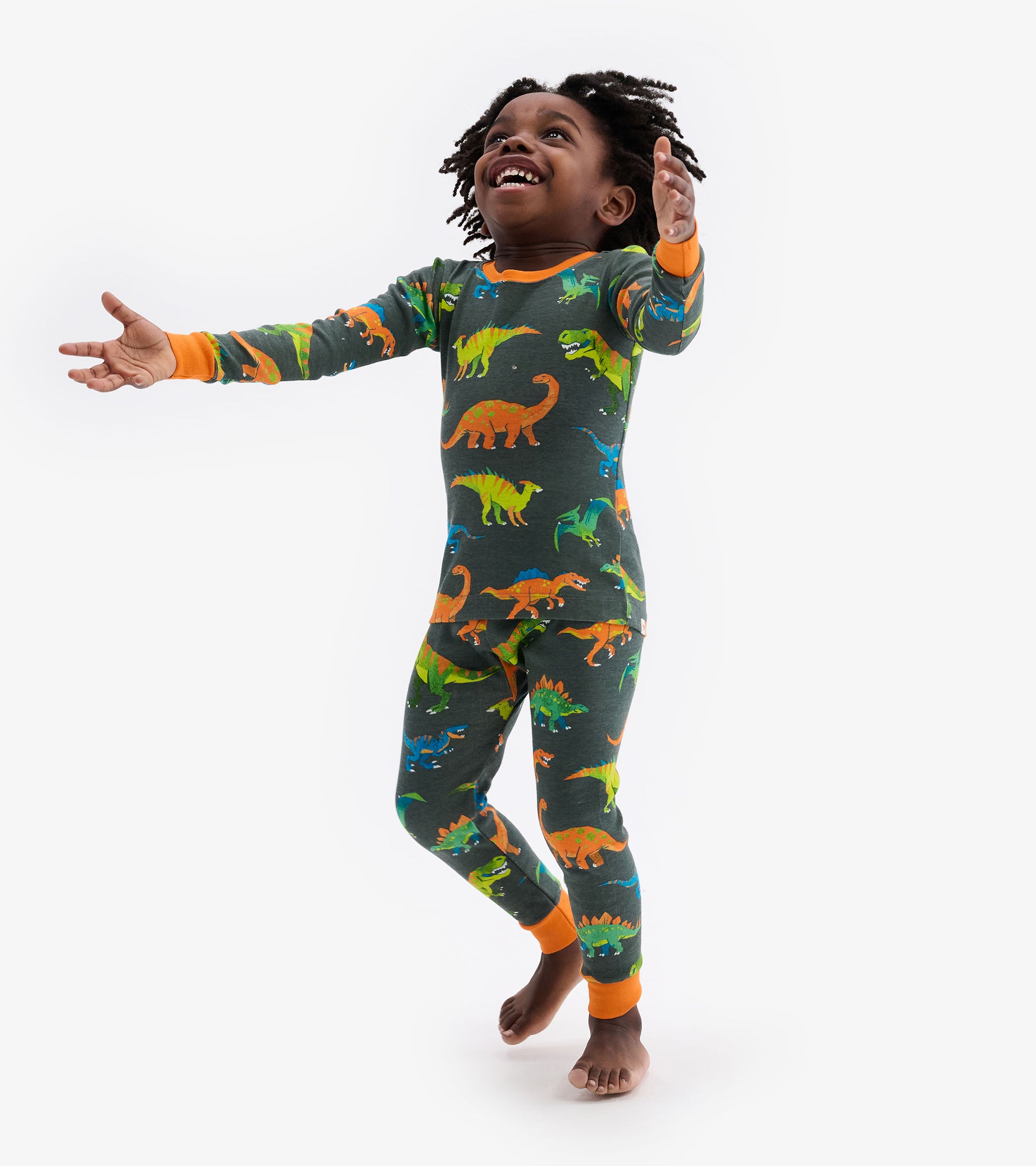 Colourful dinosaur print pajama set in dark gray with orange cuffs, designed for kids.