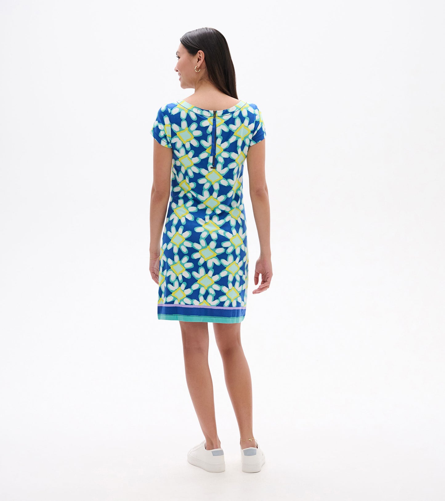 Short-sleeve dress featuring a vibrant blue background with yellow and white shibori flower patterns, shown from the back.
