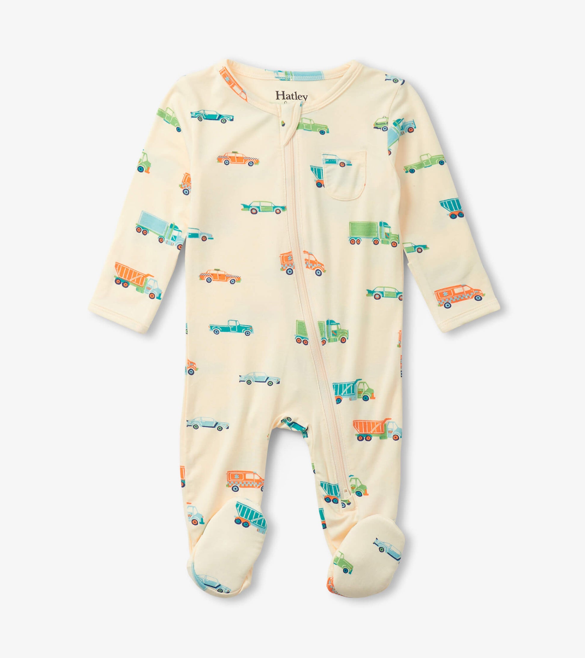Cream footed sleeper featuring colorful truck and car patterns, with long sleeves and a front zipper.