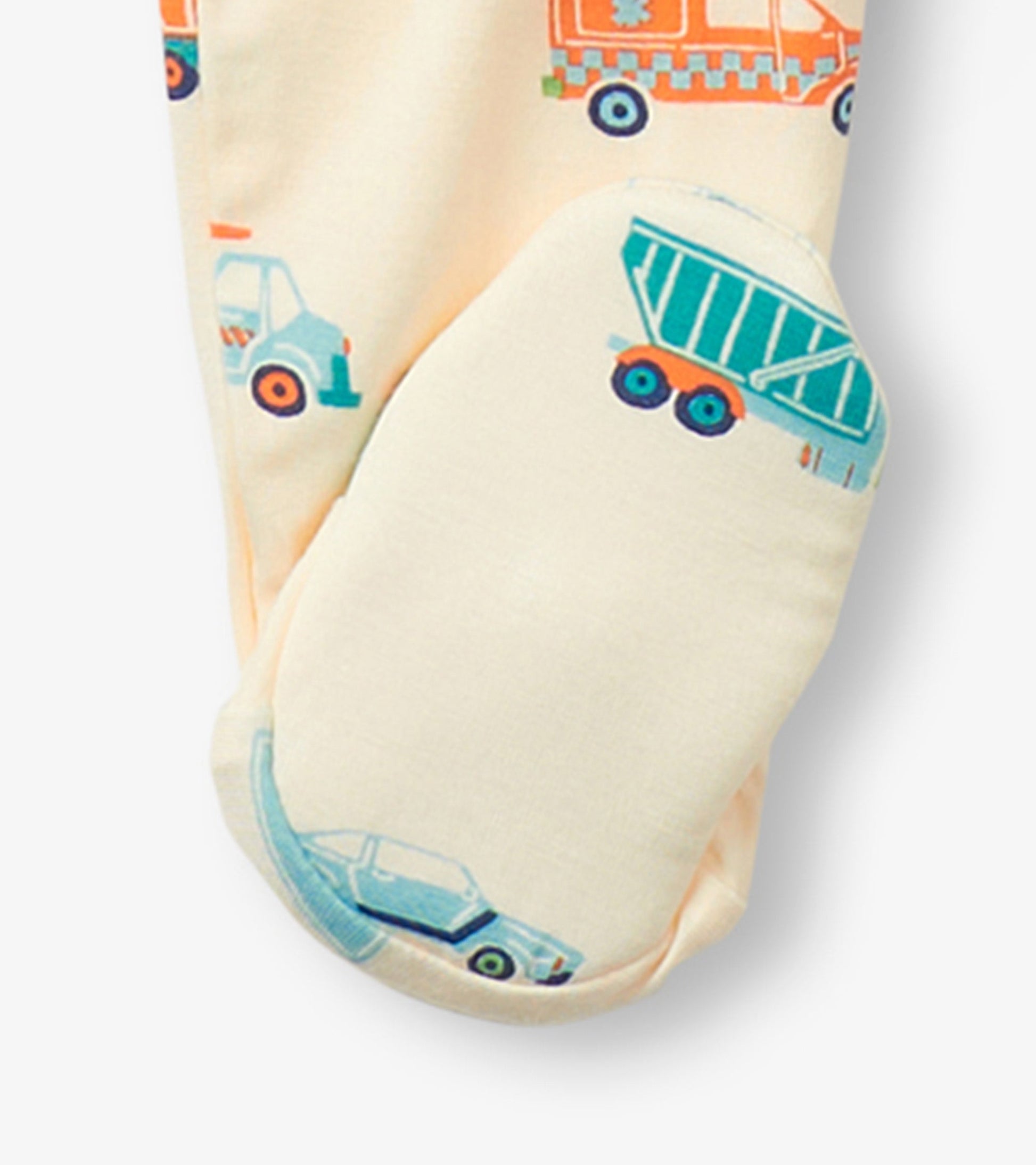 Light yellow footed sleeper featuring colorful car and truck prints, designed for baby boys.