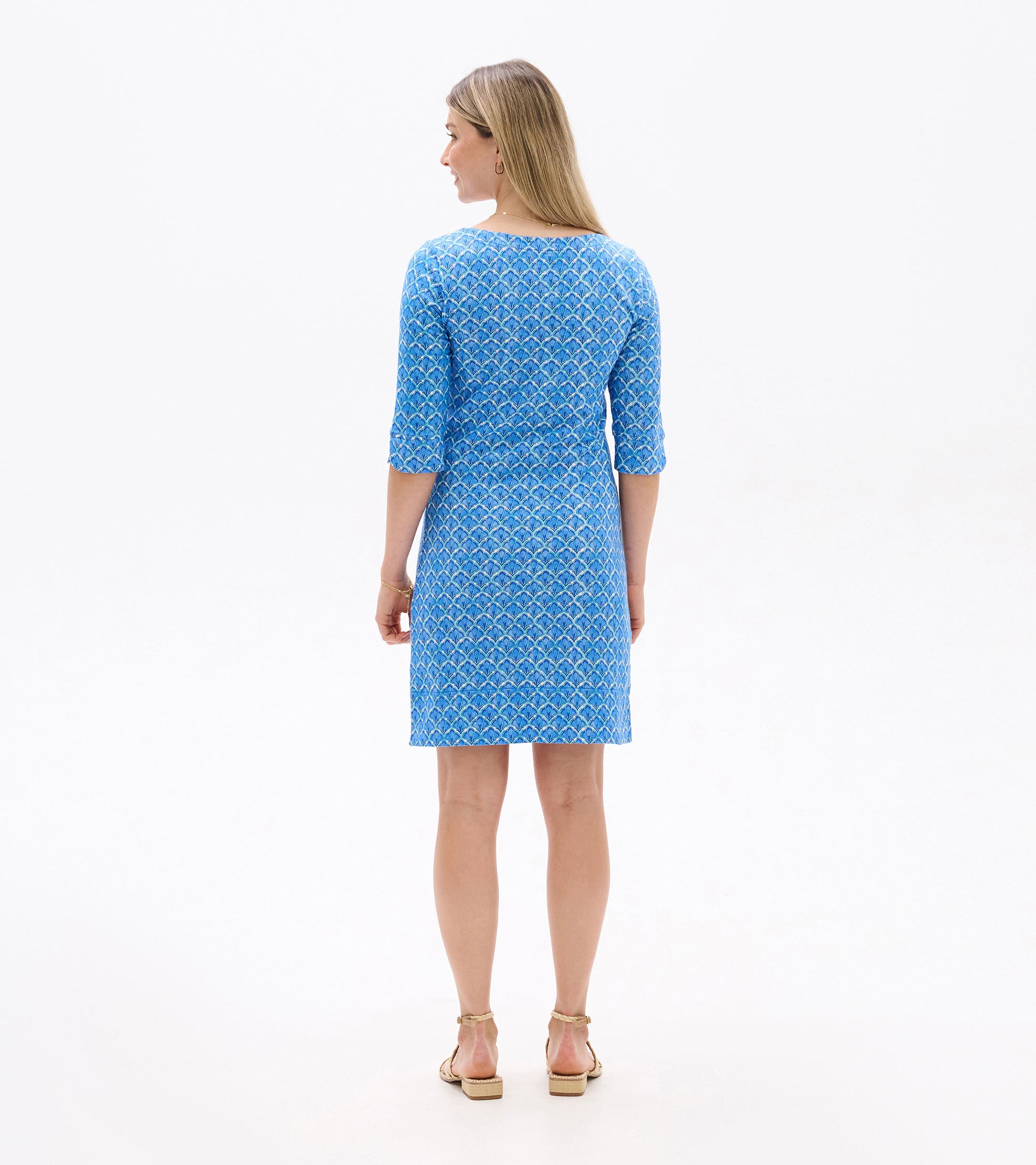 Blue dress with a mosaic glass pattern, featuring three-quarter sleeves and a fitted silhouette, shown from the back.