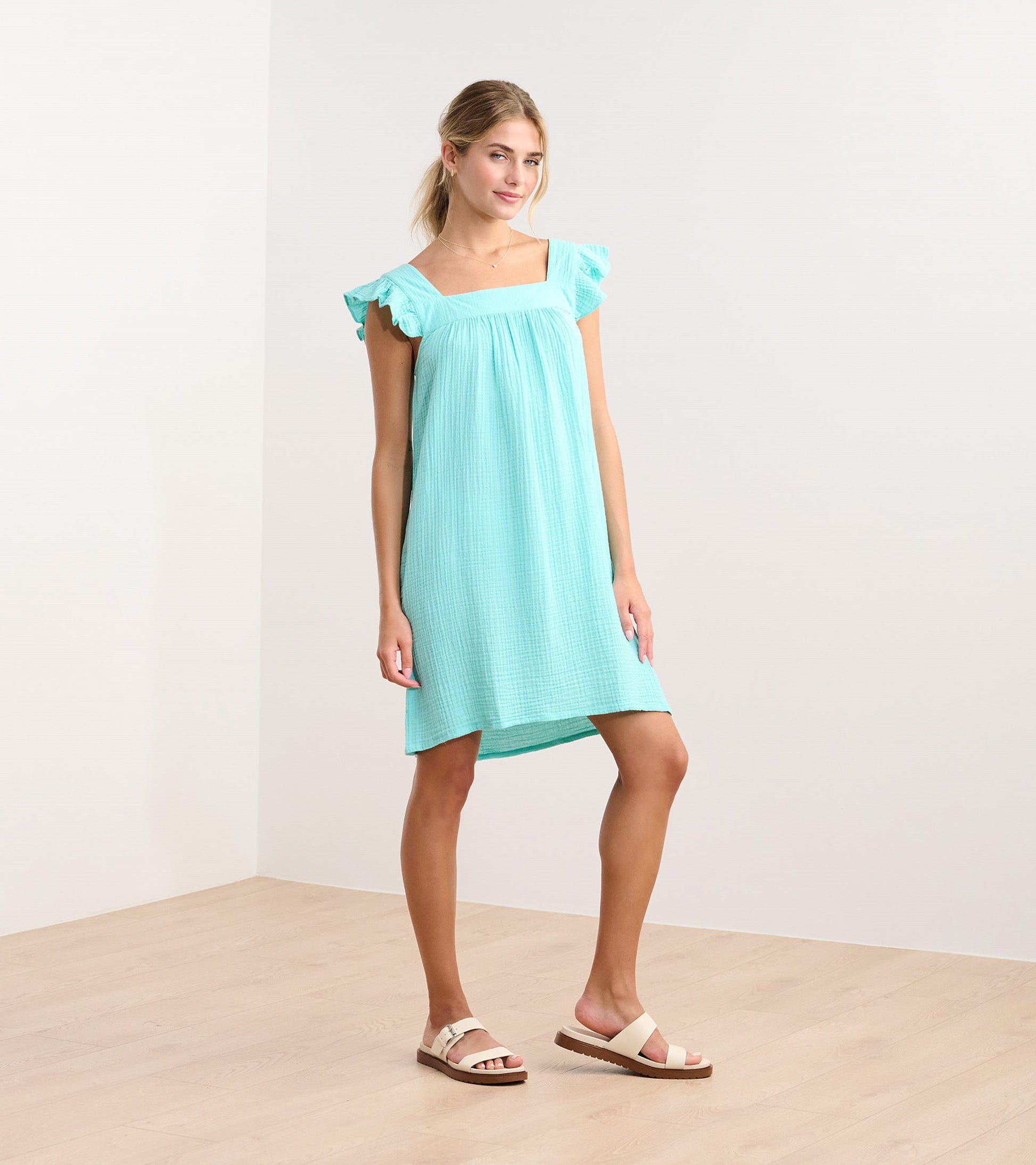 Aruba blue flutter sleeve dress with a square neckline, made from lightweight fabric, styled for casual wear.