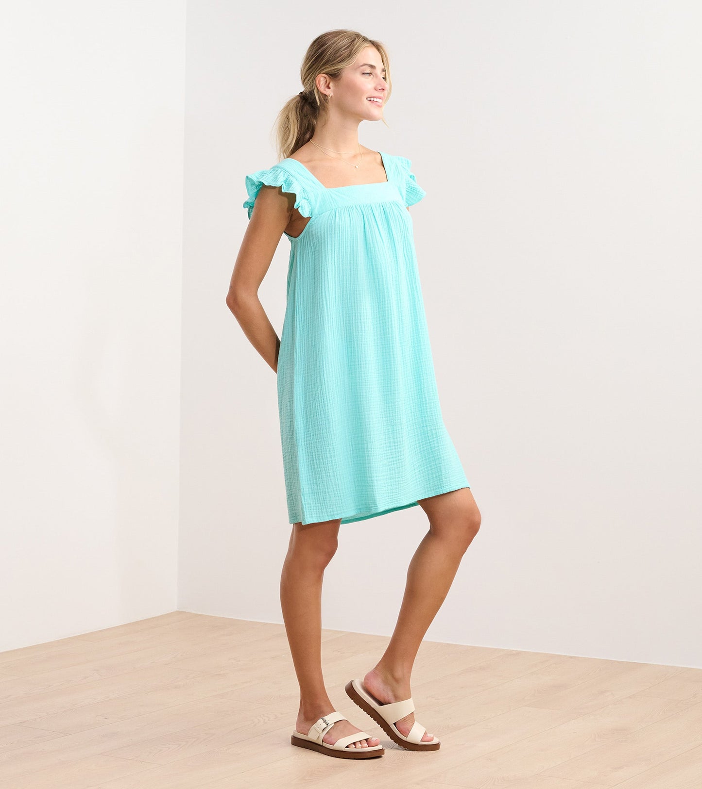Aruba blue flutter sleeve dress with a square neckline, made from lightweight fabric, styled for casual wear.