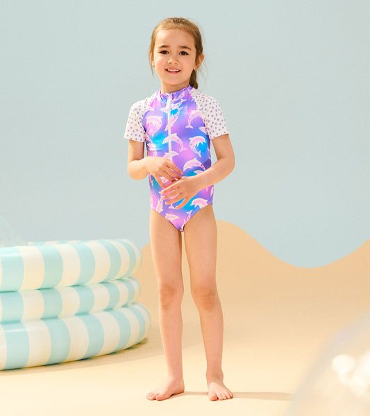 Colorful one-piece rashguard featuring dolphins, short sleeves, and a zip front, perfect for beach or pool activities.