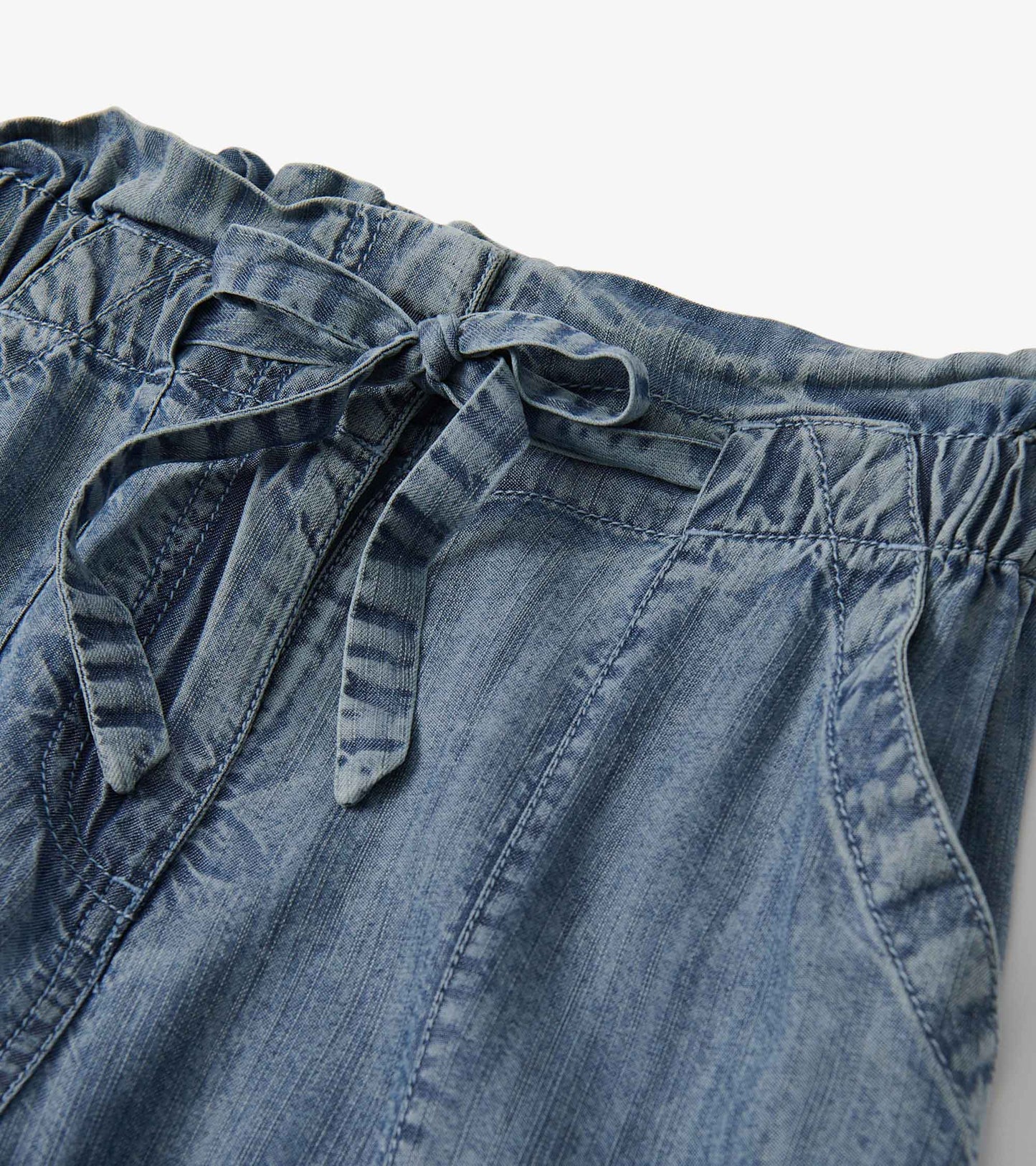 Blue acid wash tie front pants with an elastic waistband and side pockets.