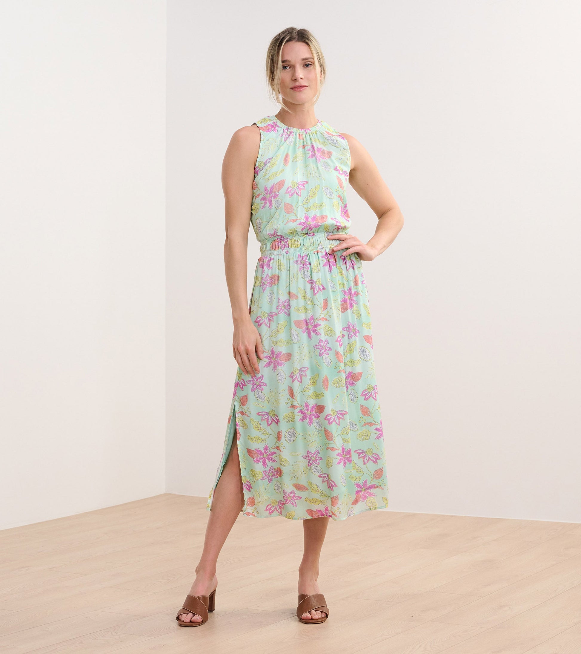 Sleeveless column dress in light green with distressed floral pattern, featuring an elastic waist and side slit.