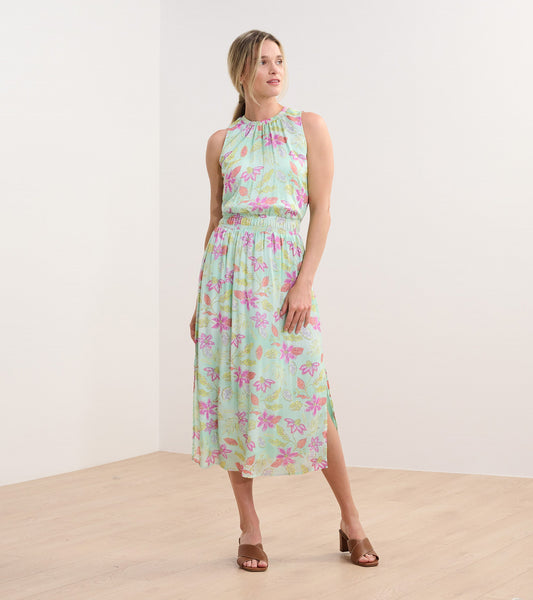 Light green column dress with distressed floral pattern, sleeveless design, and side slits, styled with brown sandals.