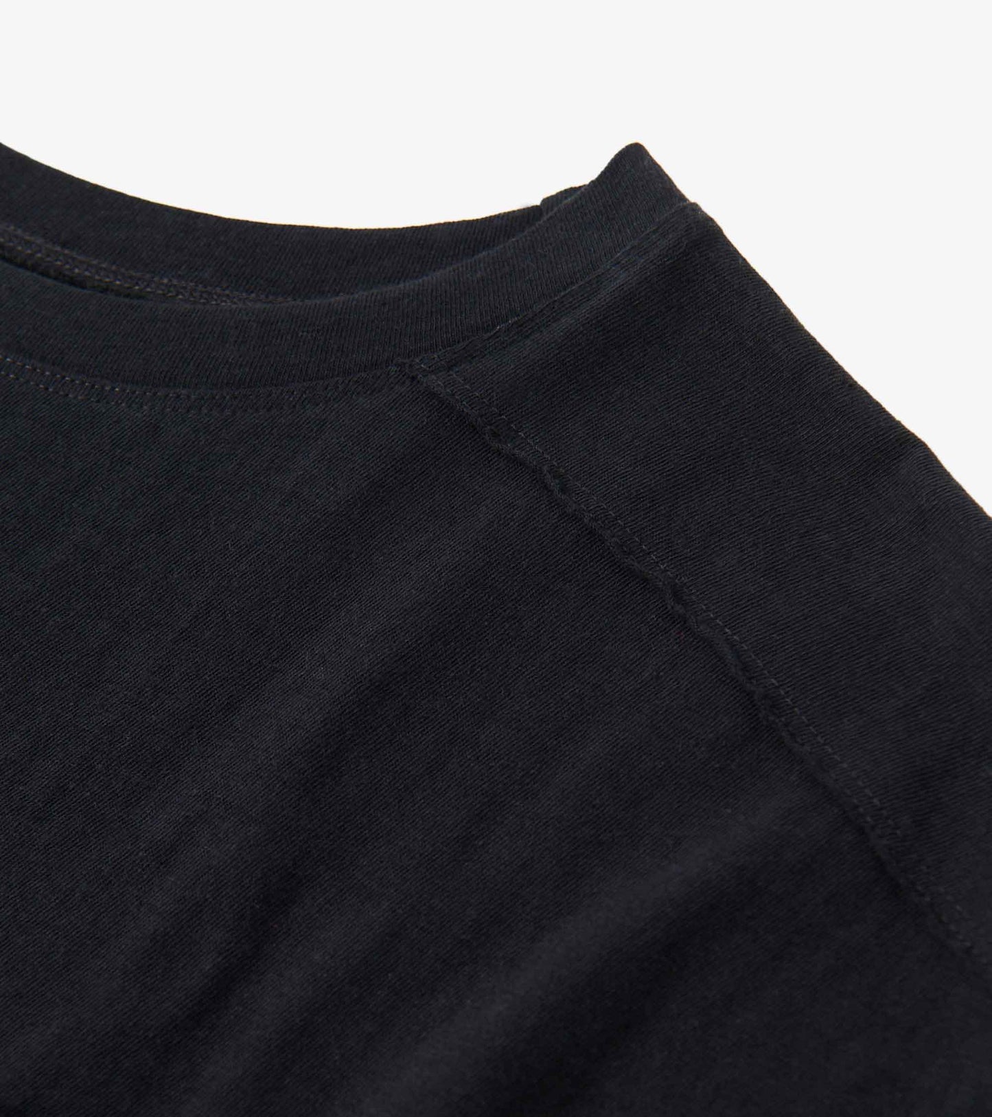 Black slouchy pocket tee with a relaxed fit and soft fabric, featuring a round neckline and visible stitching details.