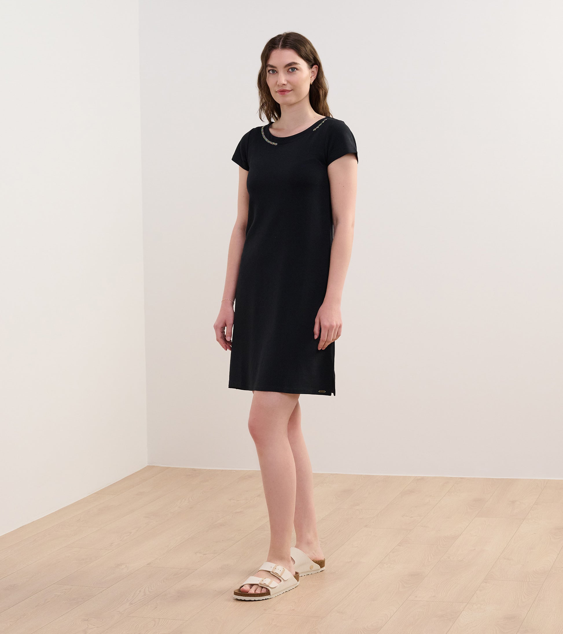 Black French terry dress with short sleeves and a relaxed fit, styled with casual sandals.