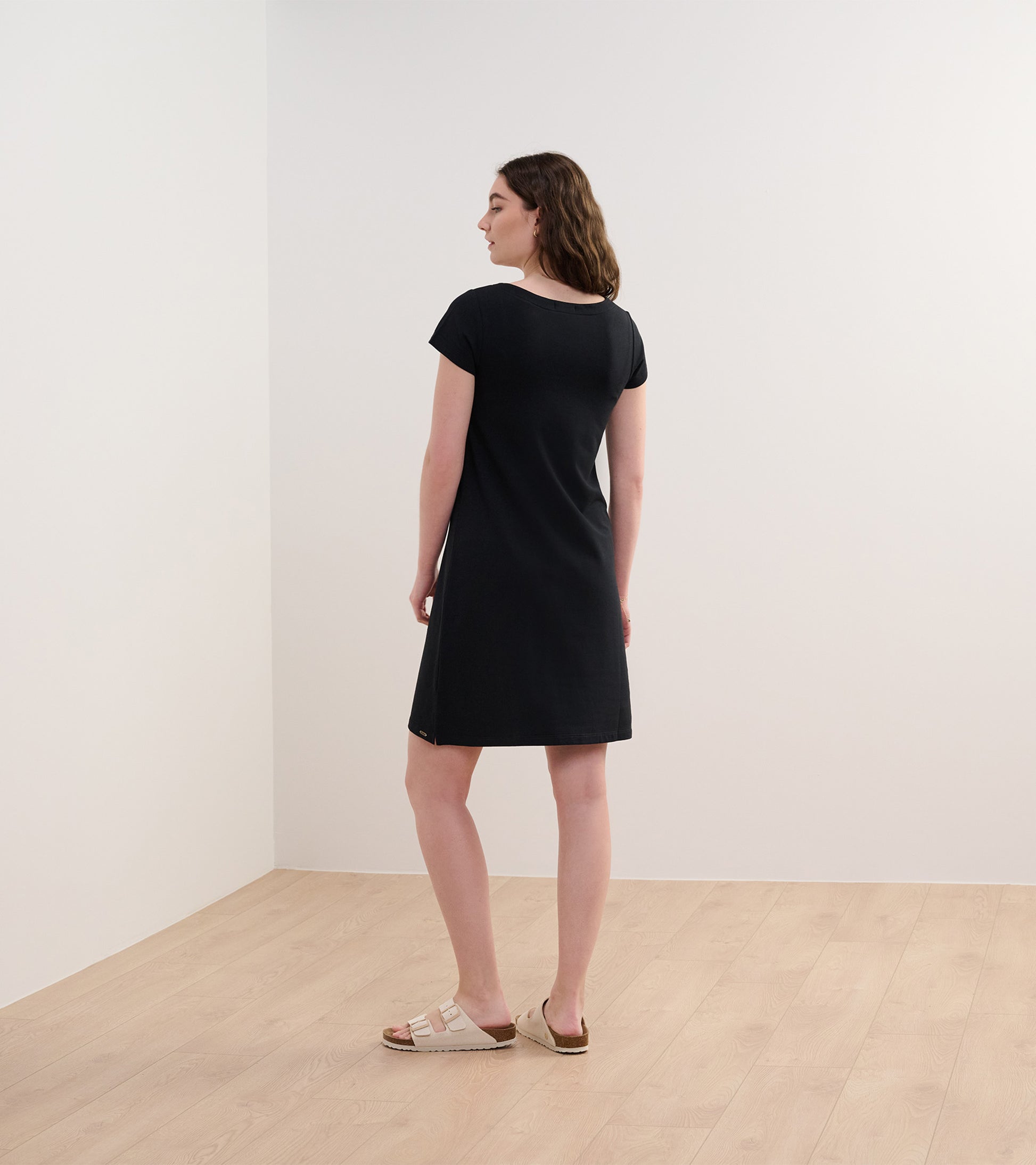 Black French terry dress with short sleeves and a relaxed fit, shown from the back.