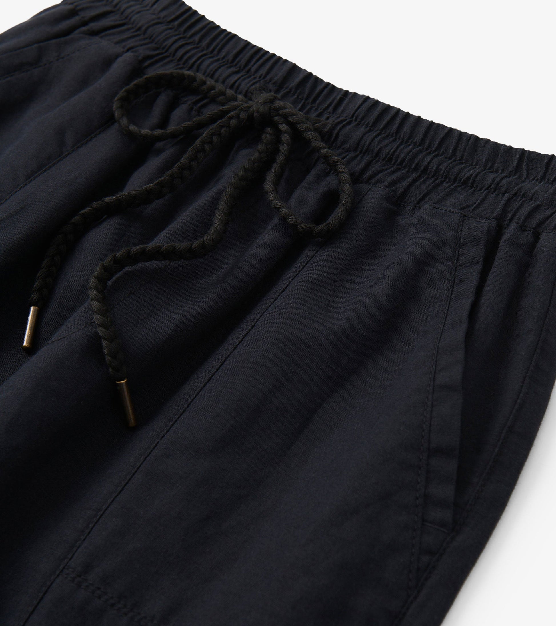 Black straight leg linen pants featuring an elastic waistband and drawstring detail.