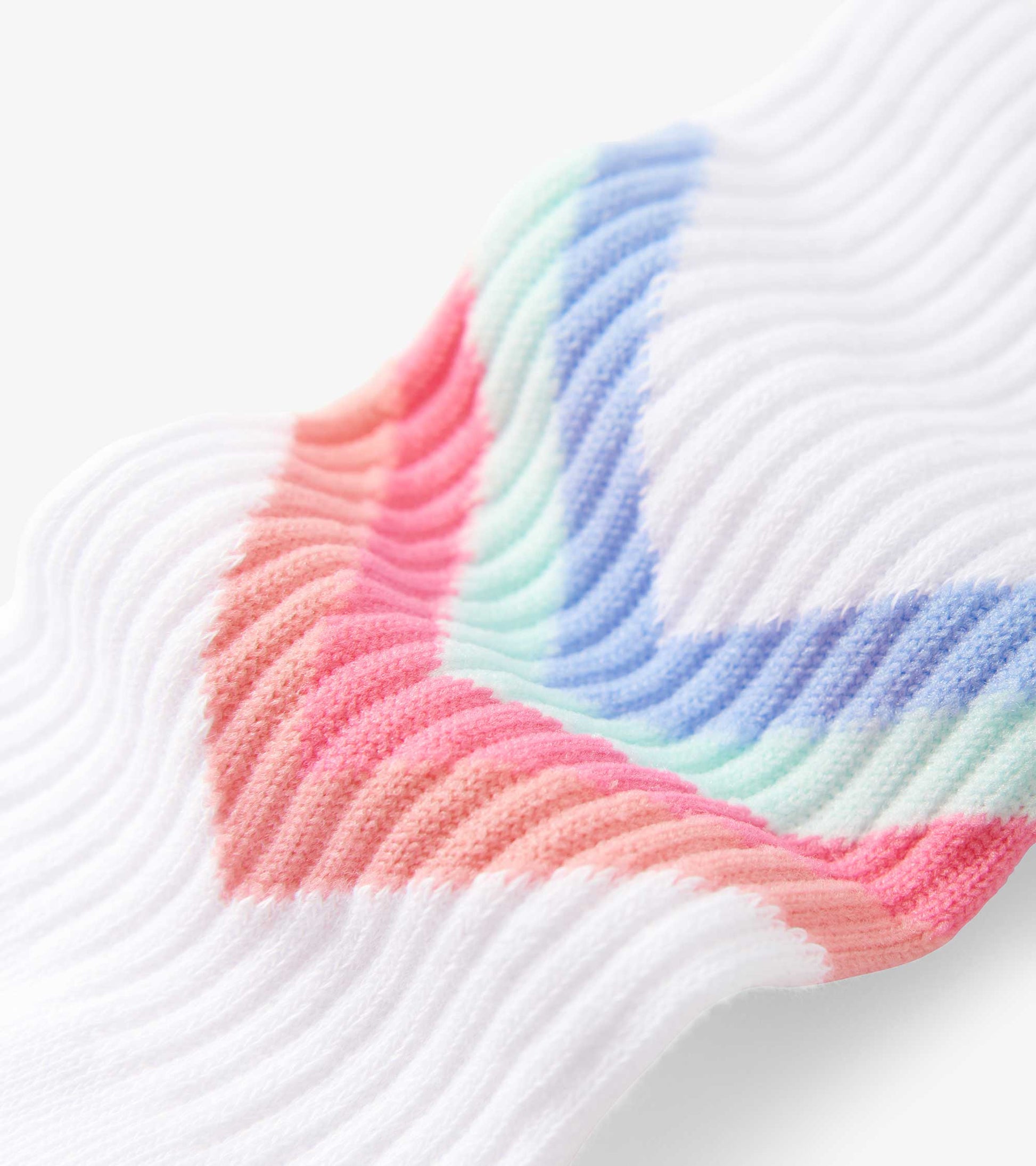 Colorful chevron-patterned tube socks in pastel shades of pink, blue, and mint, made from soft knit material.