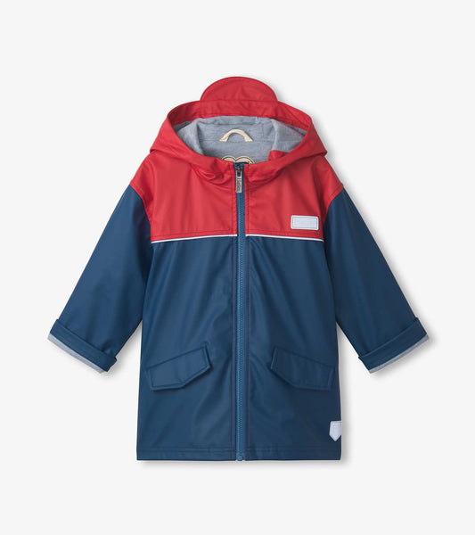 Red and navy zip-up rain jacket with a hood, featuring two front pockets and a reflective trim.