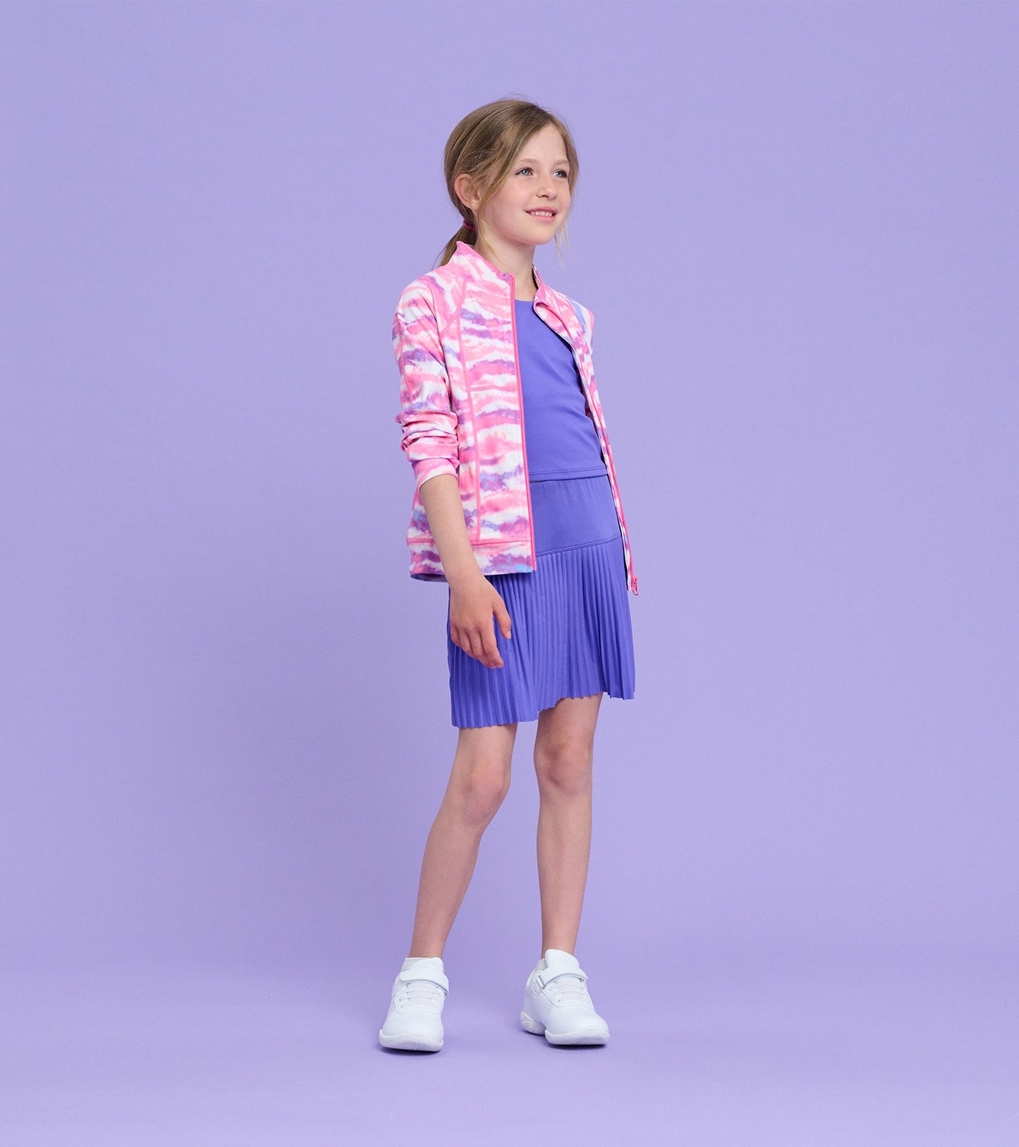 Ombre pink and purple active jacket worn over a purple dress, featuring a zip front and long sleeves.