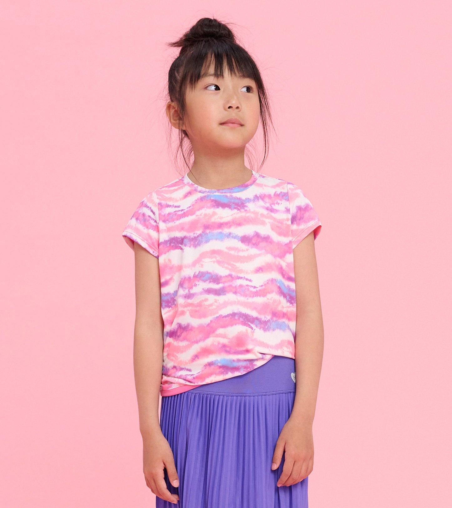 Girls' short-sleeve t-shirt featuring a candy ombre pattern in pink and purple, paired with a pleated purple skirt.