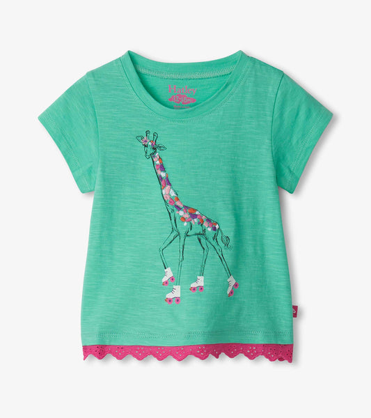 Green short-sleeve t-shirt featuring a colorful giraffe graphic and eyelet trim at the hem.