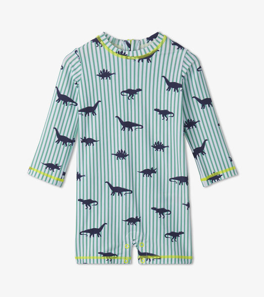 Light blue one-piece rashguard with navy dinosaur prints and green stripes, featuring long sleeves and snap closures.