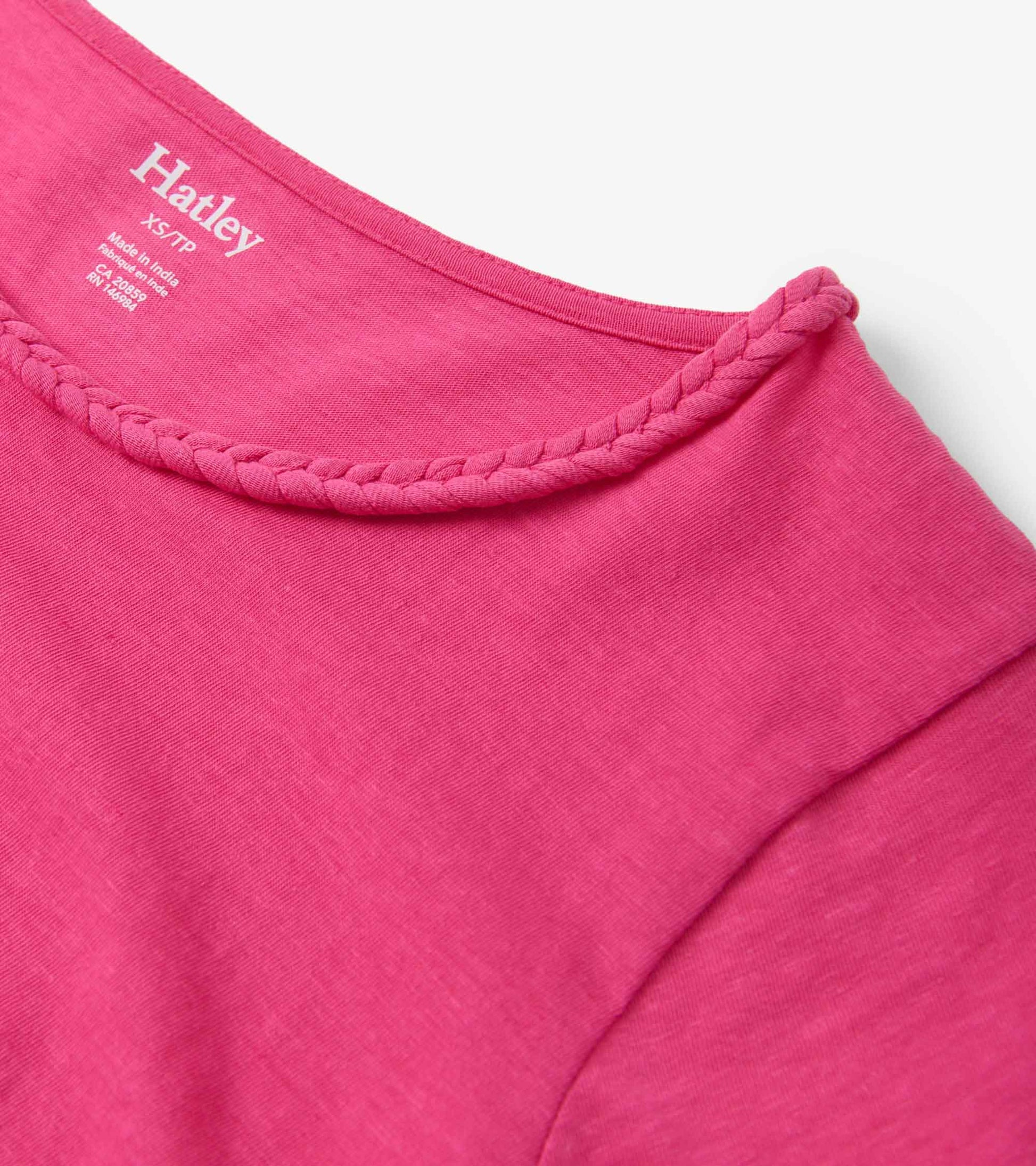 Fuschia braided neck tee with a soft fabric, showcasing a round neckline and short sleeves.