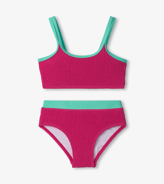 Fuchsia purple bikini set with textured fabric and teal accents, featuring a crop top and matching high-waisted bottoms.