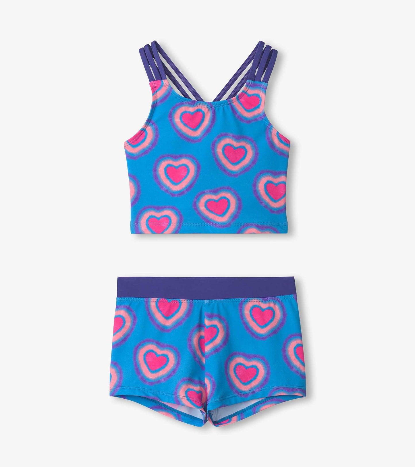Two-piece short swimsuit featuring a blue background with pink heart patterns and purple accents on straps and waistband.