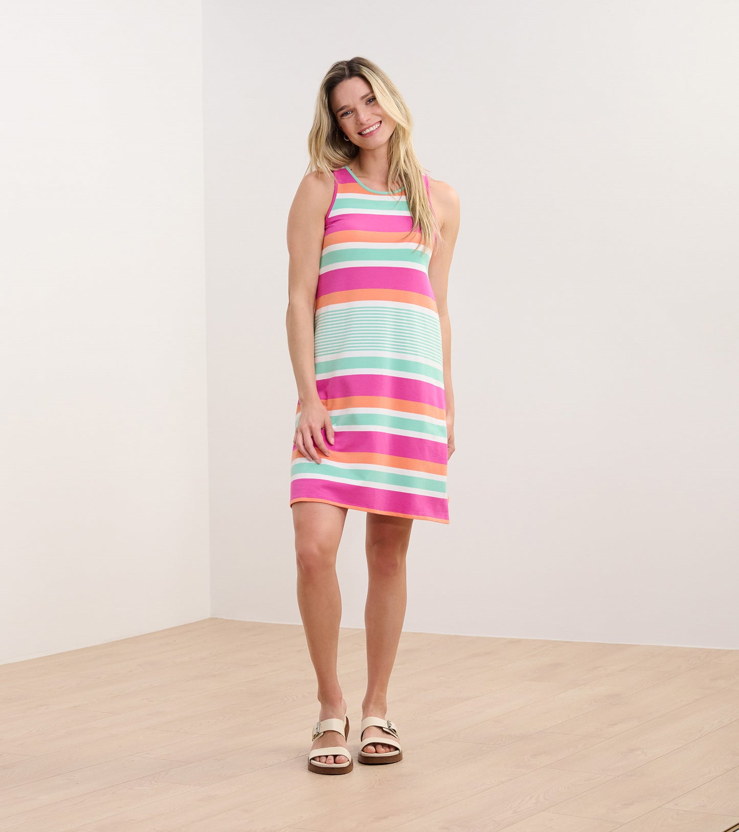 Sleeveless dress featuring hot fuchsia and pastel stripes, knee-length, perfect for casual summer outings.
