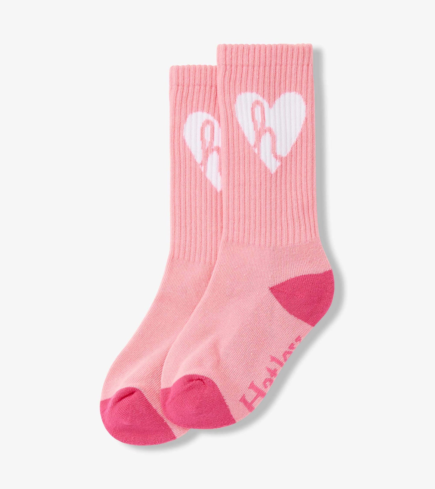 Pink ribbed tube socks featuring a white heart design and contrasting pink toe and heel. Suitable for ages 2-12.