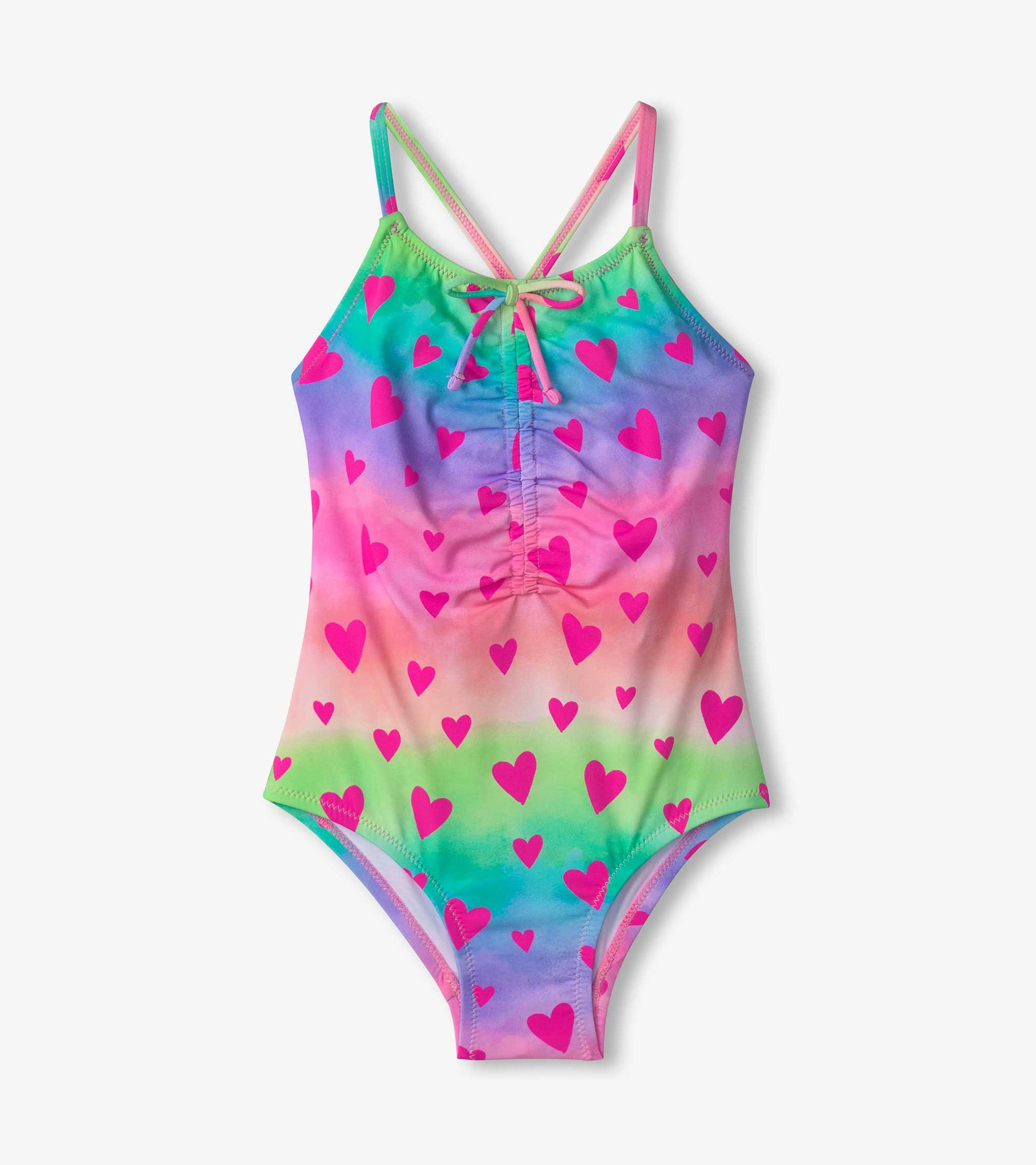 Colorful swimsuit featuring a ruched front and a kaleidoscope of hearts in pink, purple, and green hues.