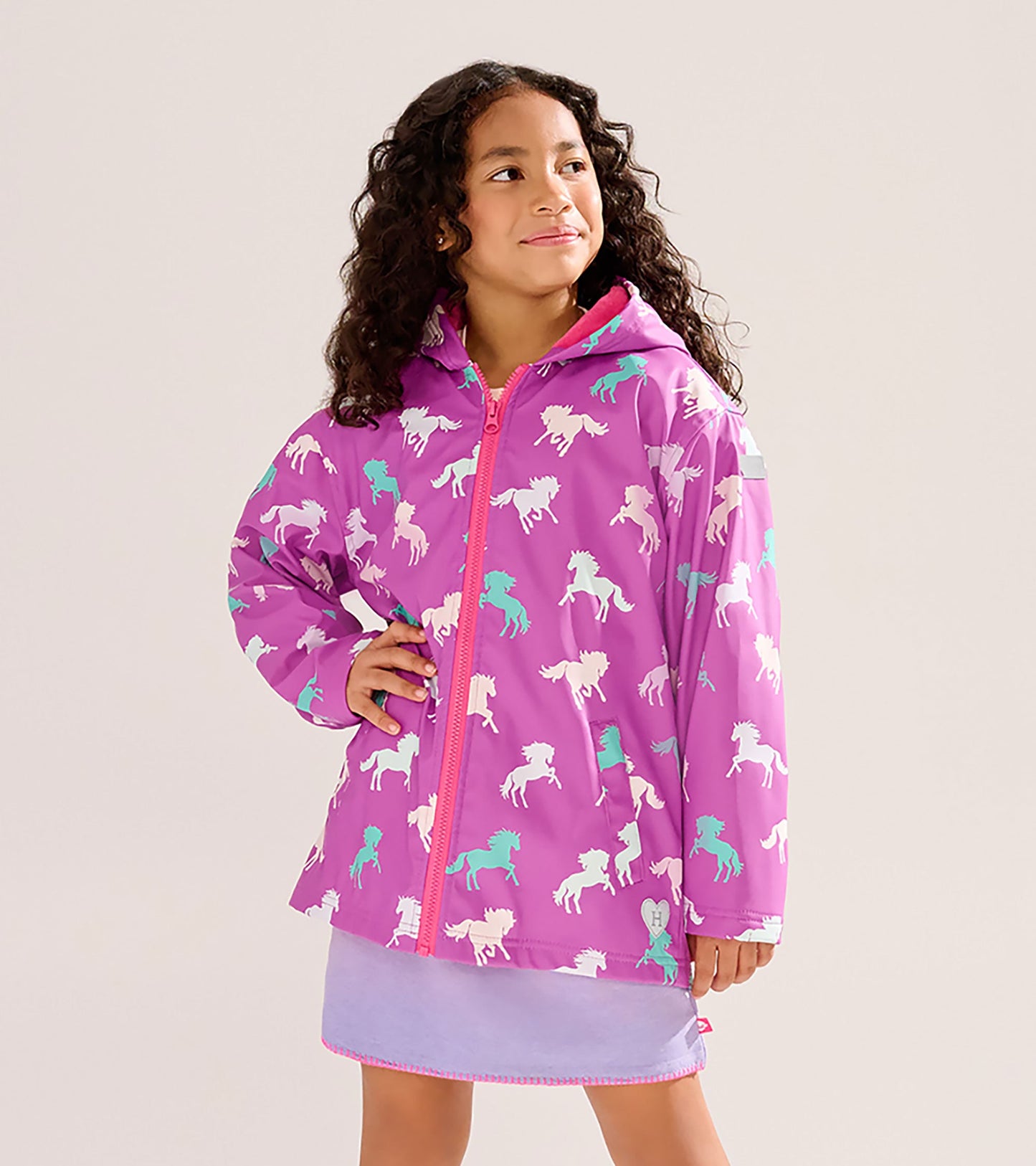 Purple zip-up rain jacket featuring colorful leaping horse patterns, designed for girls.