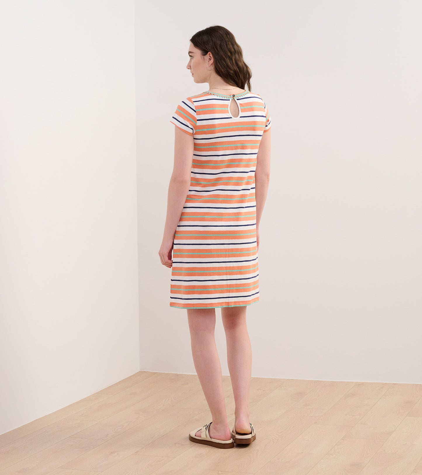 A-line dress in melon stripes with short sleeves and a keyhole back detail, shown from the back.