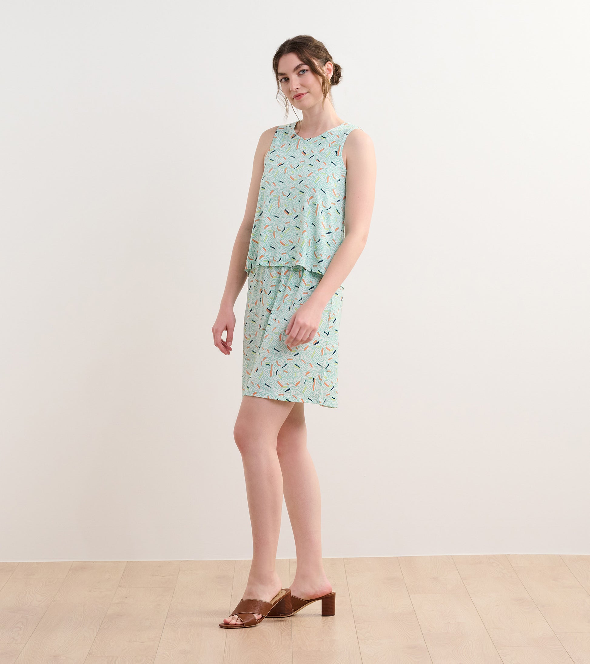Light blue sleeveless dress with an organic leaf pattern, featuring a relaxed fit and a layered design.