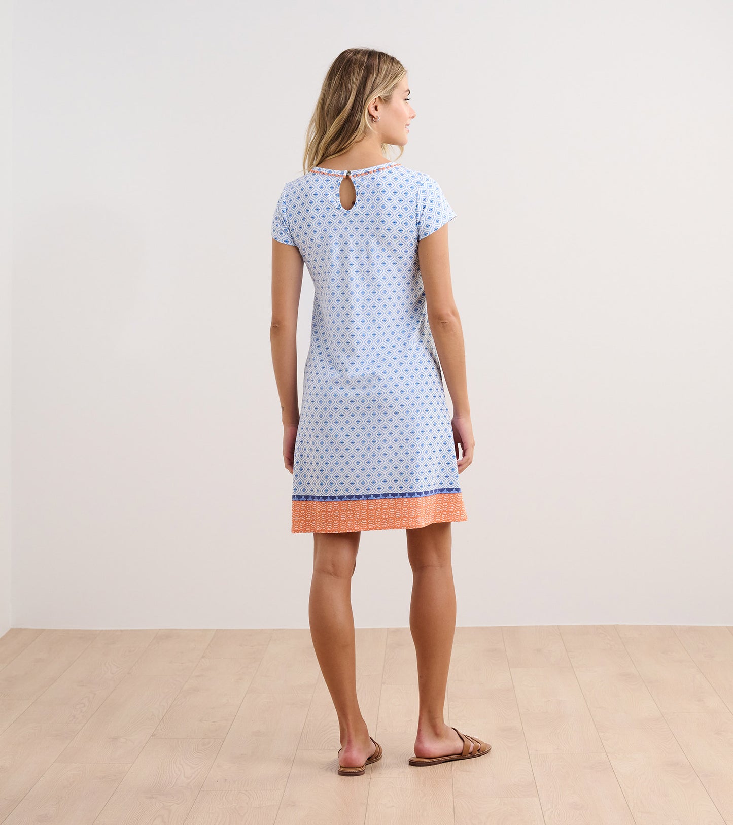 Light blue A-line dress with a diamond pattern and orange trim, featuring a keyhole back and short sleeves.