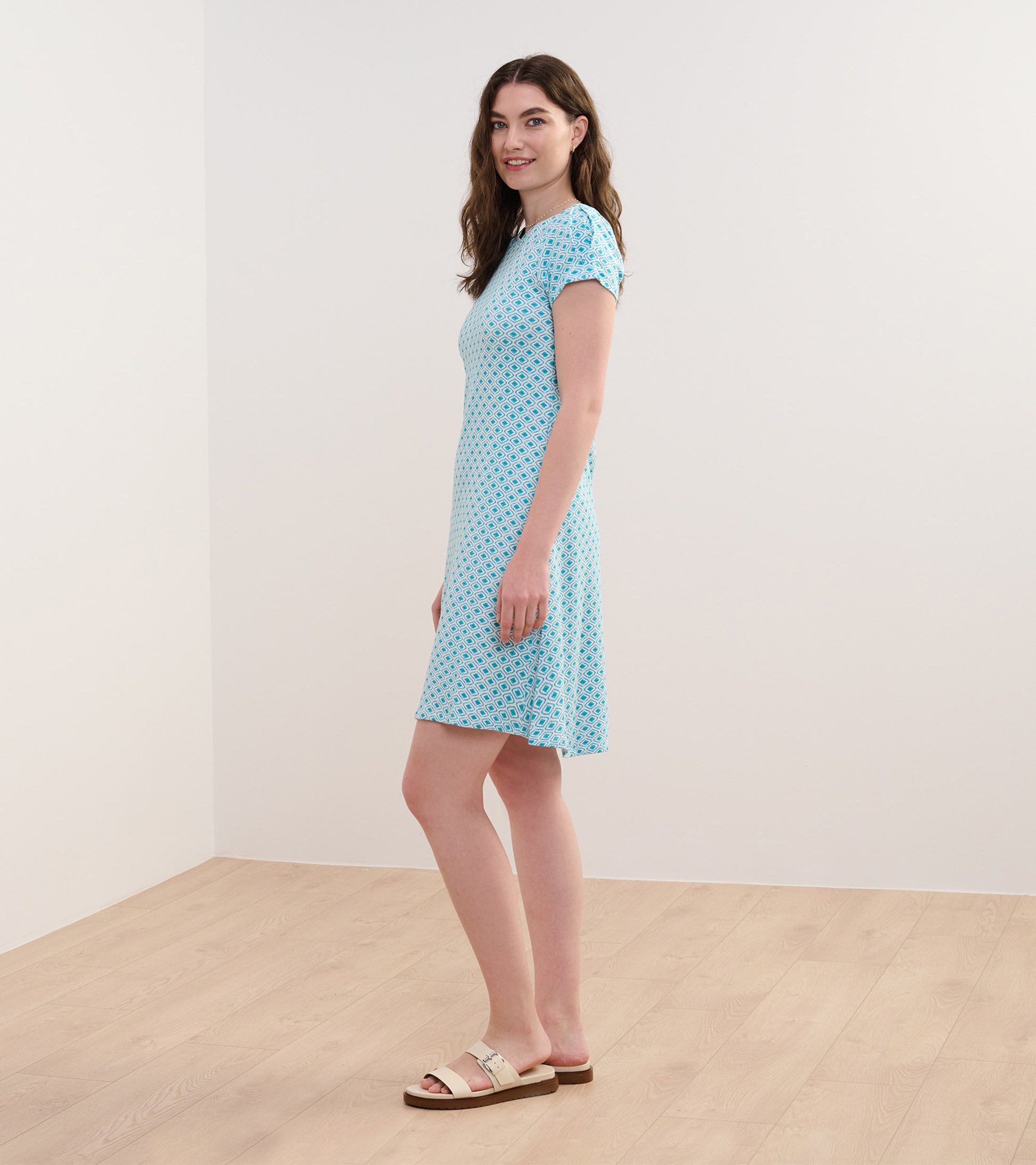 Light blue short-sleeve dress with a geometric pattern, featuring a relaxed fit and knee-length hem.