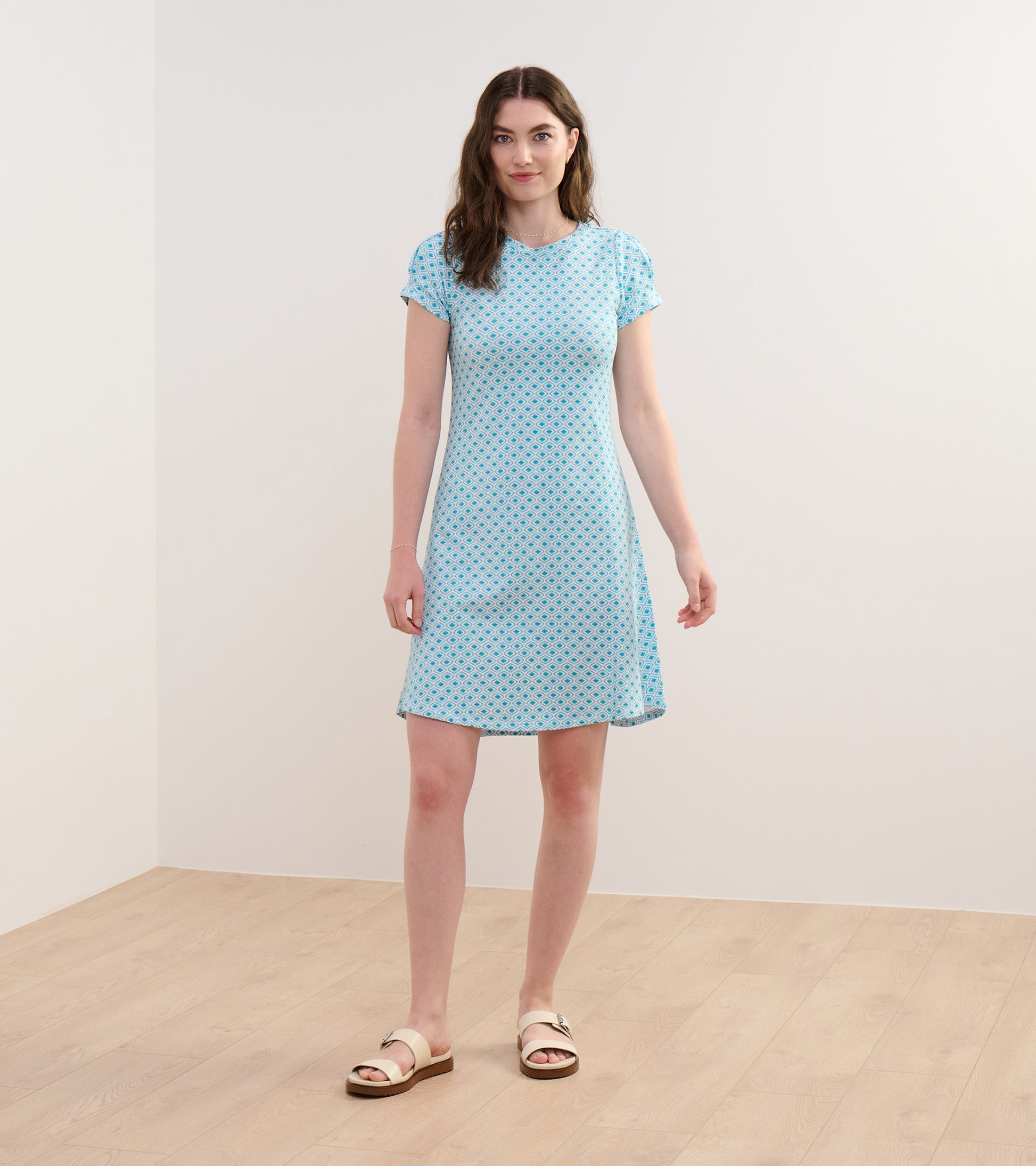 Light blue dress with a floral pattern, short sleeves, and a relaxed fit, suitable for casual wear.