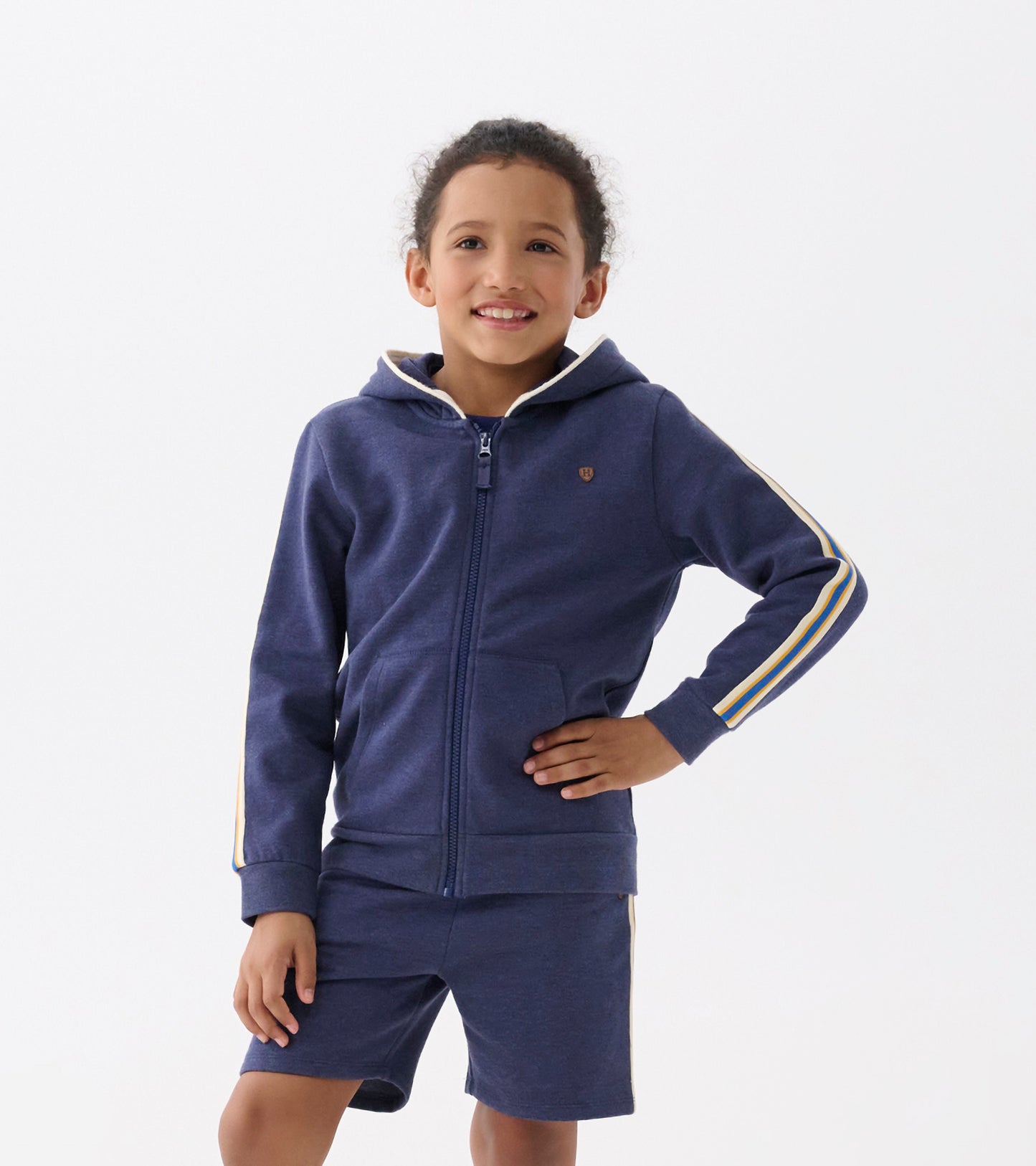 Patriot blue zip-up hoodie with a front zipper, hood, and striped accents on sleeves, worn by a smiling child.