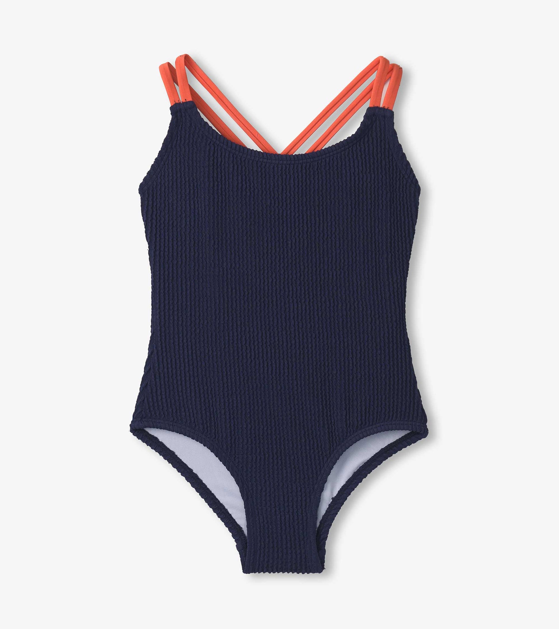 Patriot blue ribbed swimsuit with coral cross straps, designed for girls, featuring a classic one-piece silhouette.