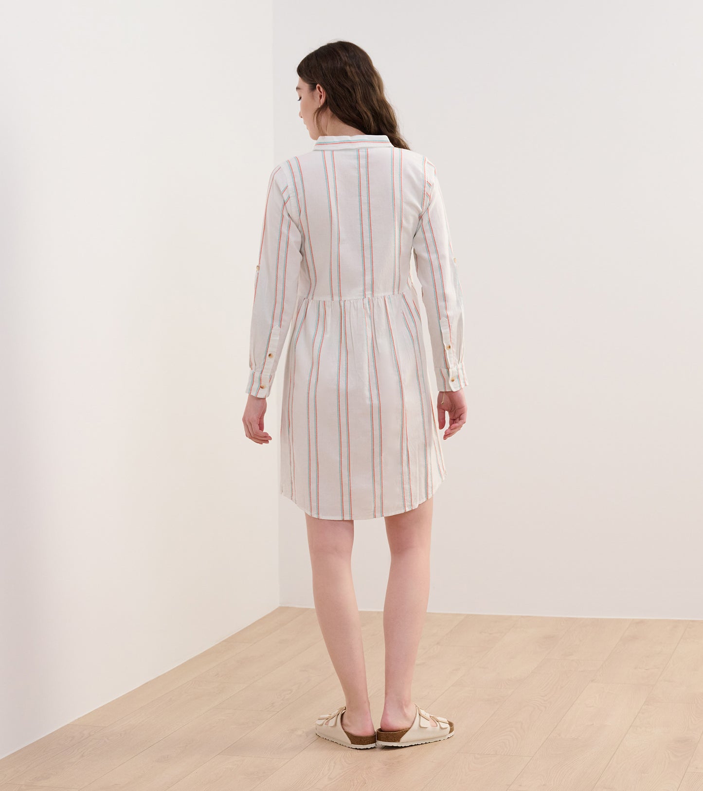 Peach and white shirt dress with chain stripes, featuring a cinched waist and long sleeves, shown from the back.