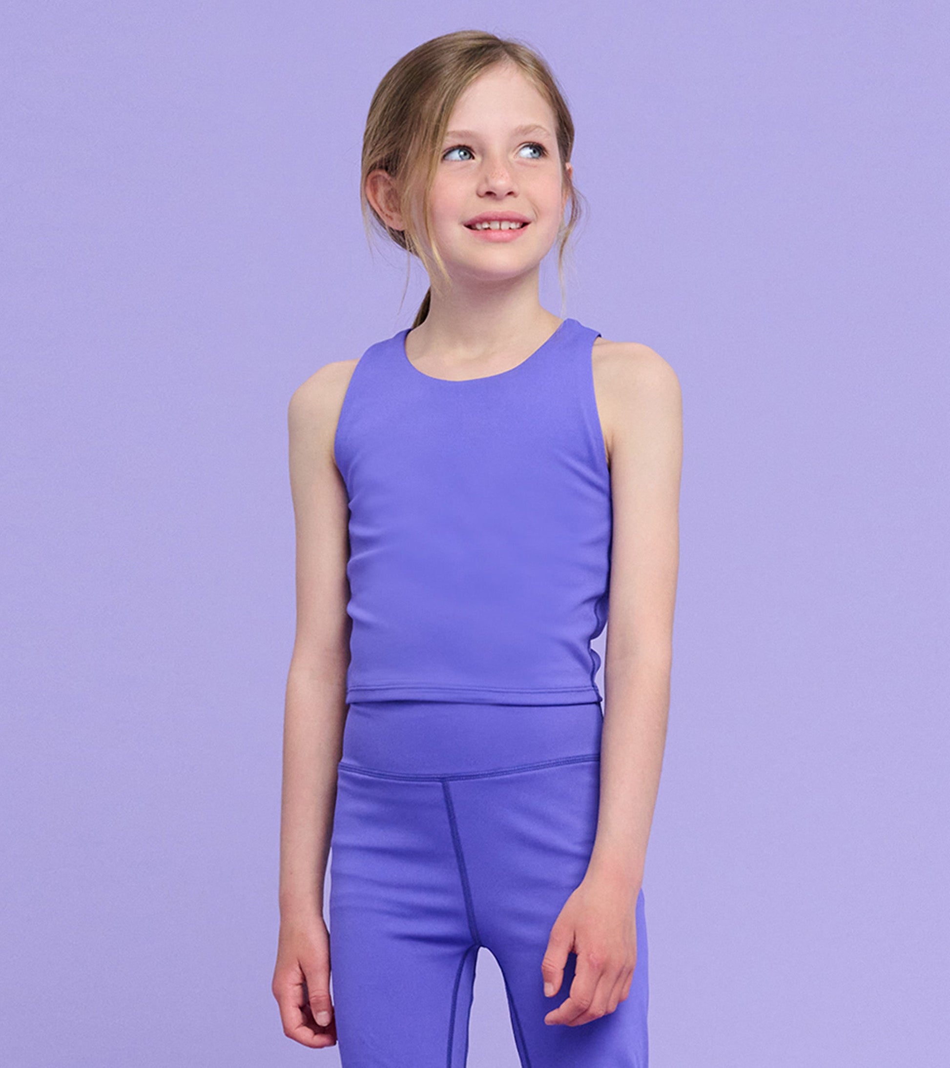 Purple tank top for girls, featuring a sleeveless design and a fitted shape, suitable for casual wear or active play.