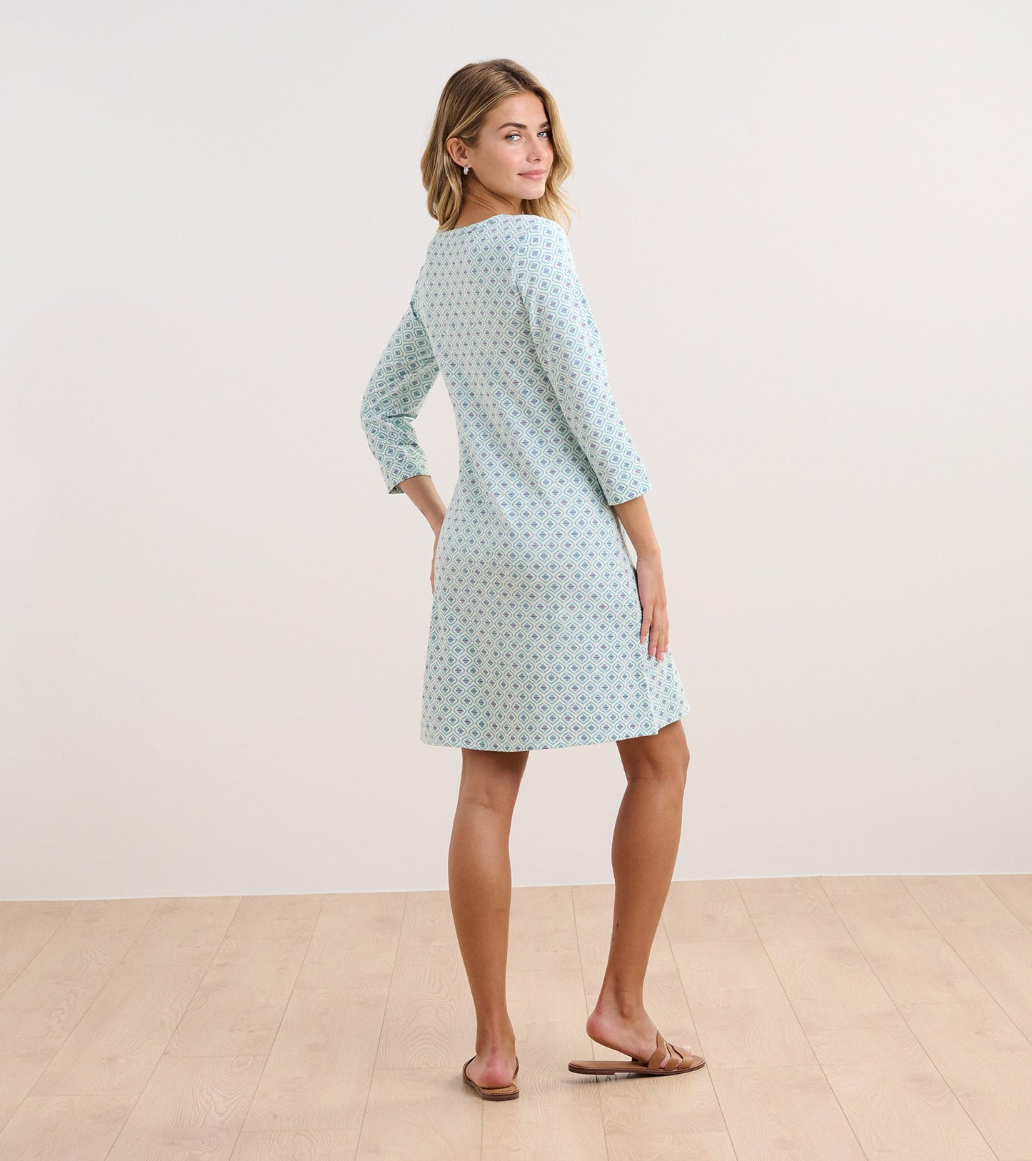 Light blue dress with a diamond pattern, three-quarter sleeves, and a flared silhouette, shown from the back.