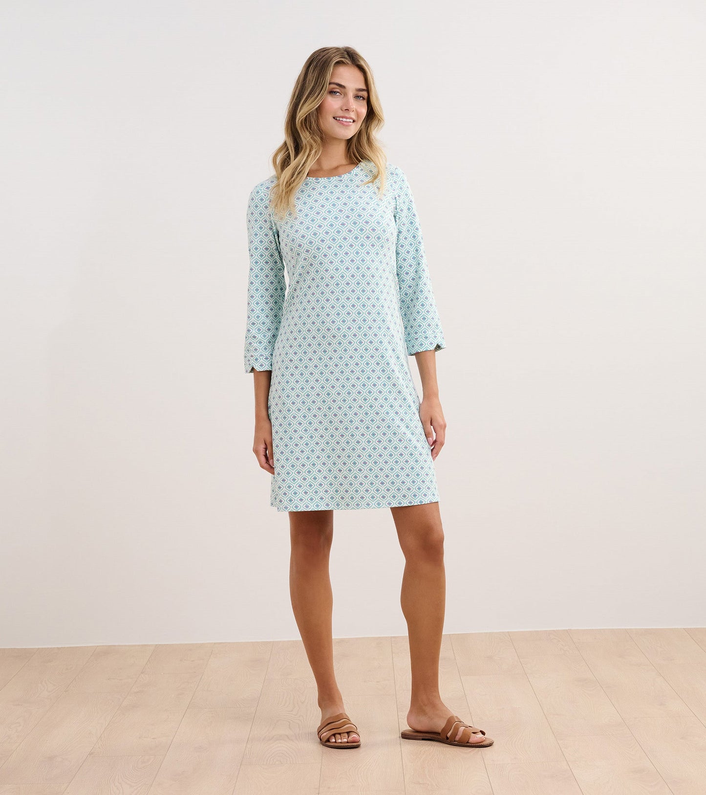Light blue dress with a geometric pattern, three-quarter sleeves, and a relaxed fit, suitable for casual wear.