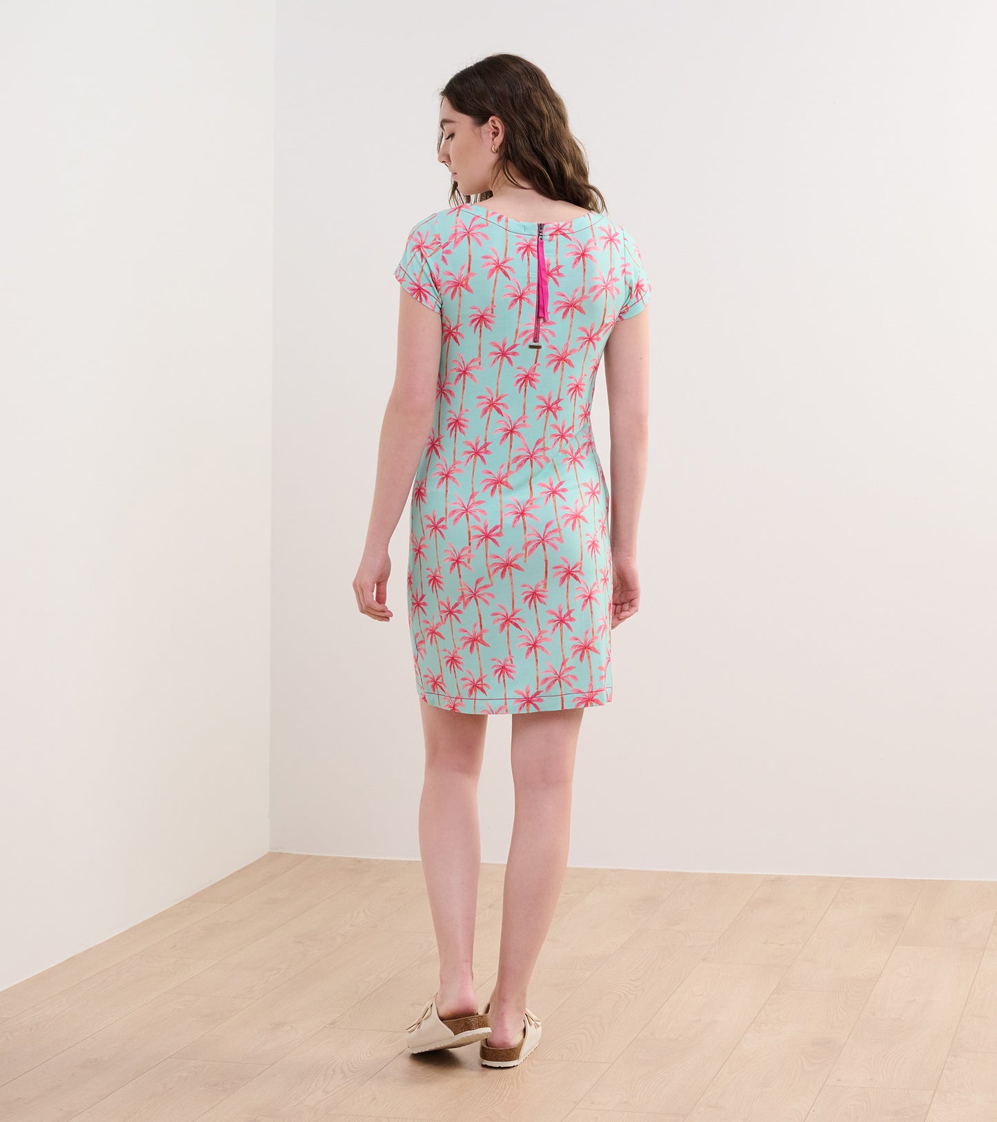 Short-sleeve dress in light blue with pink palm tree pattern, featuring a back keyhole detail.