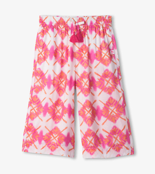 Cropped culottes featuring a pink and orange sunburst pattern with a drawstring waist and tassel detail.
