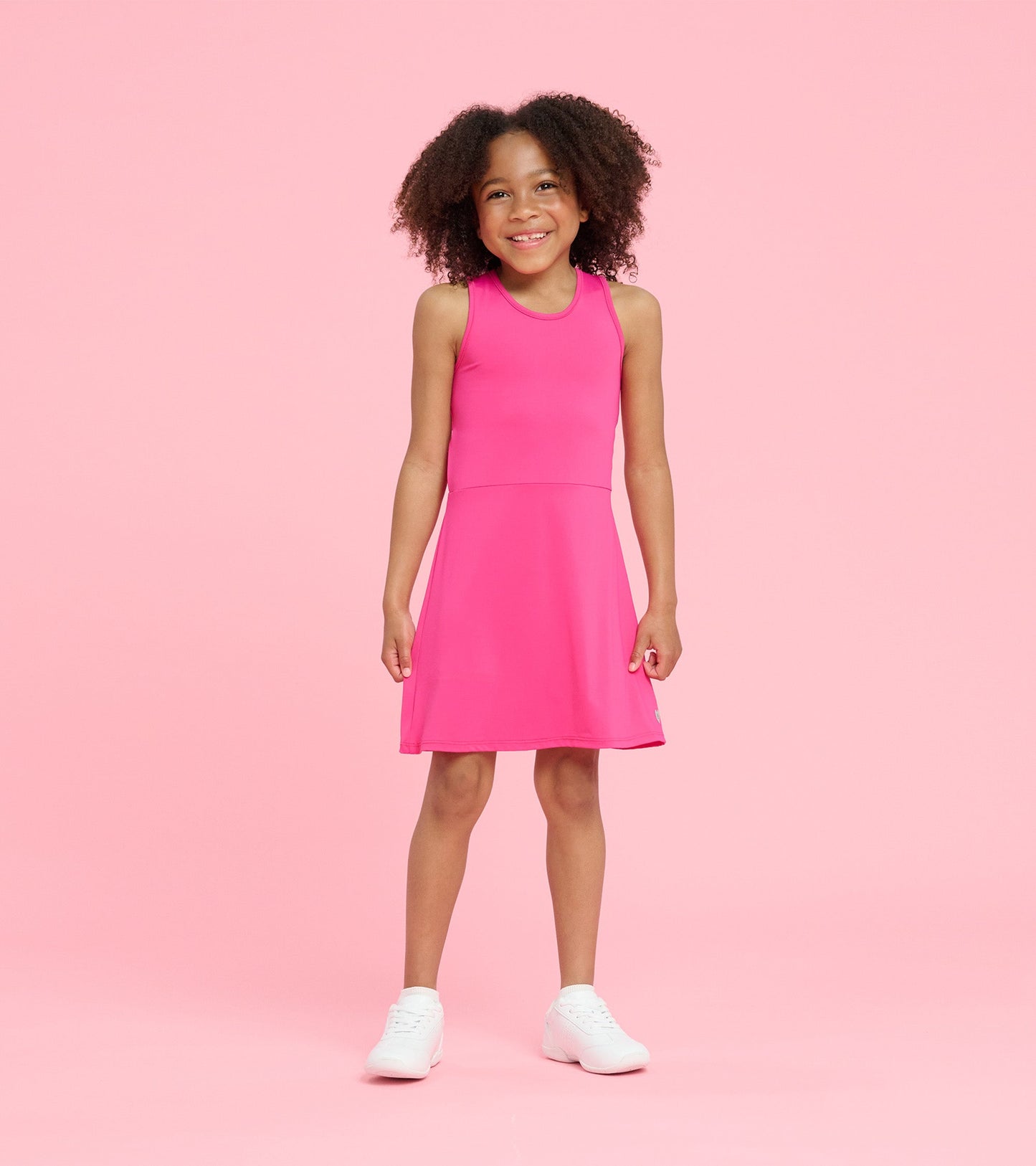 Bright pink A-line dress with a sleeveless design, perfect for active play, worn by a smiling girl.