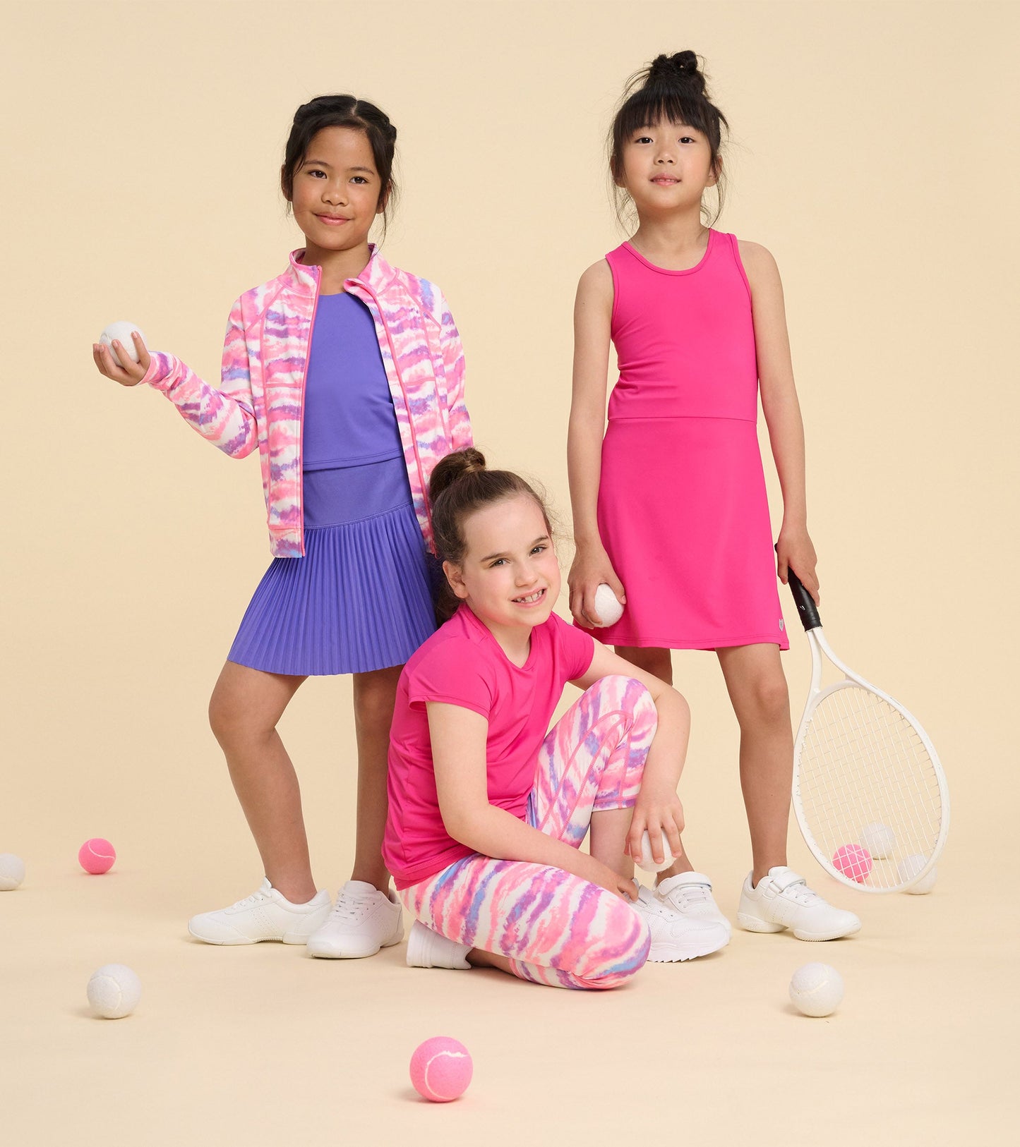 Girls' pink active A-line dress, sleeveless design, suitable for sports, paired with playful accessories and athletic shoes.