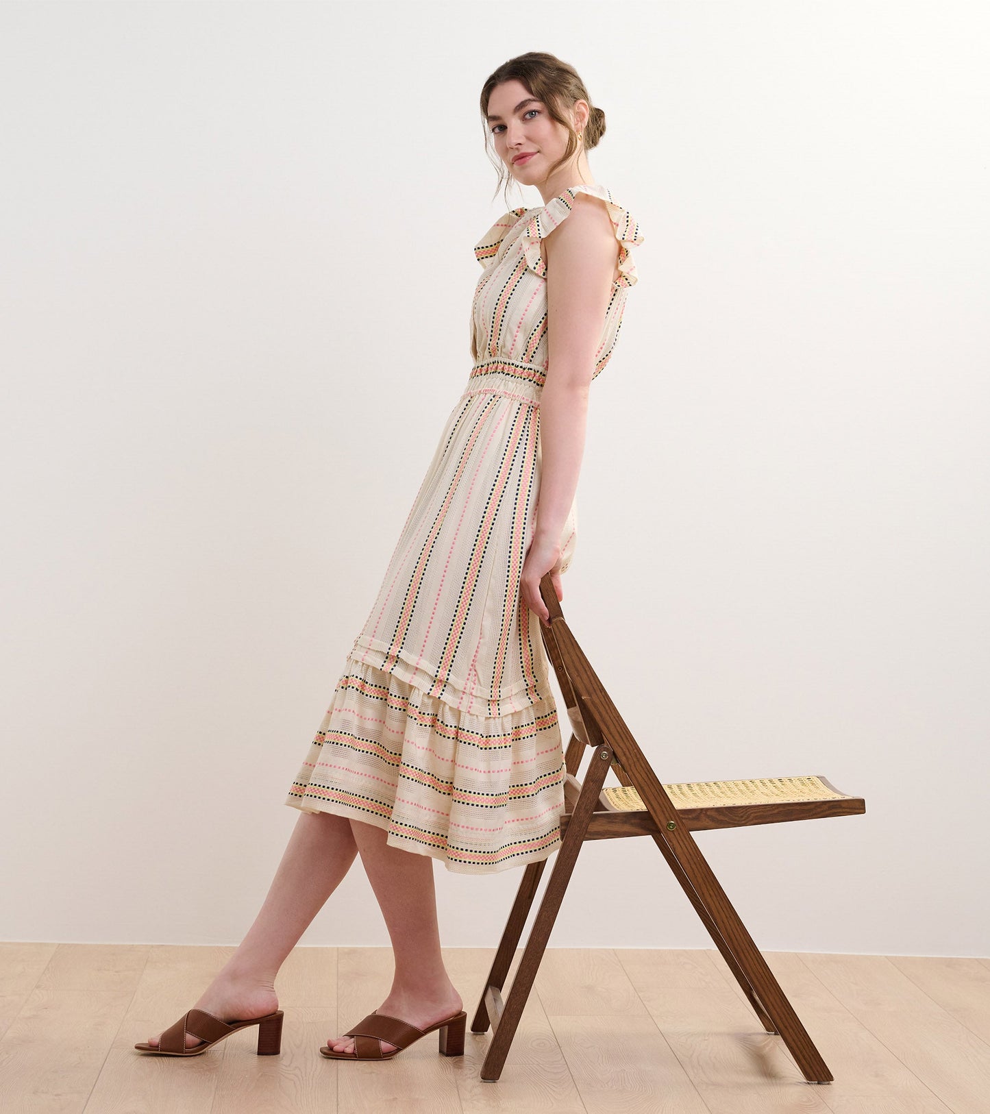 Midi dress with ruffled shoulders, featuring ribbon weave stripes in pastel colors and a flared hem.